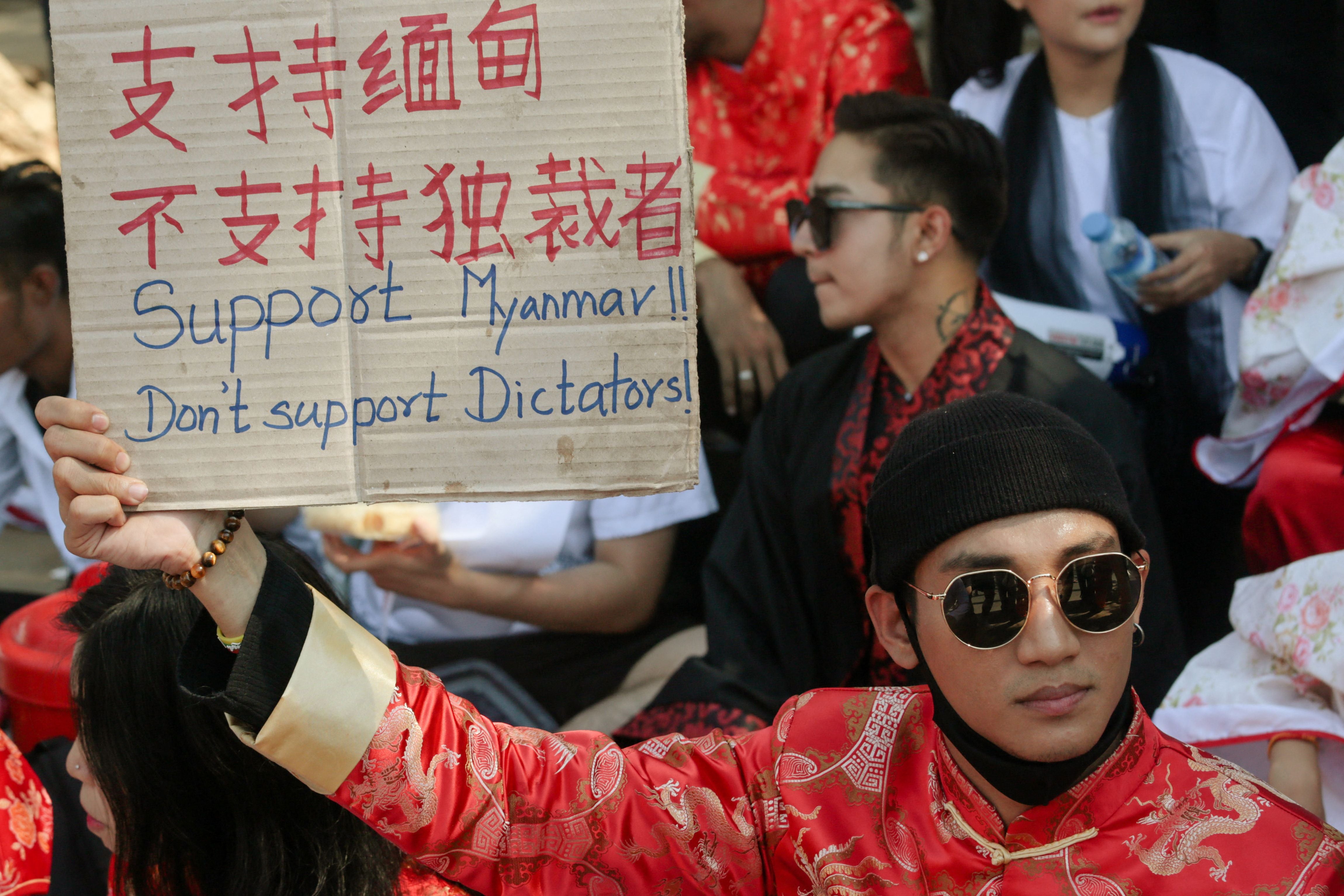 File: Paing Takhon hols a sign during a demonstration against the military coup in Yangon on 11 February 2021