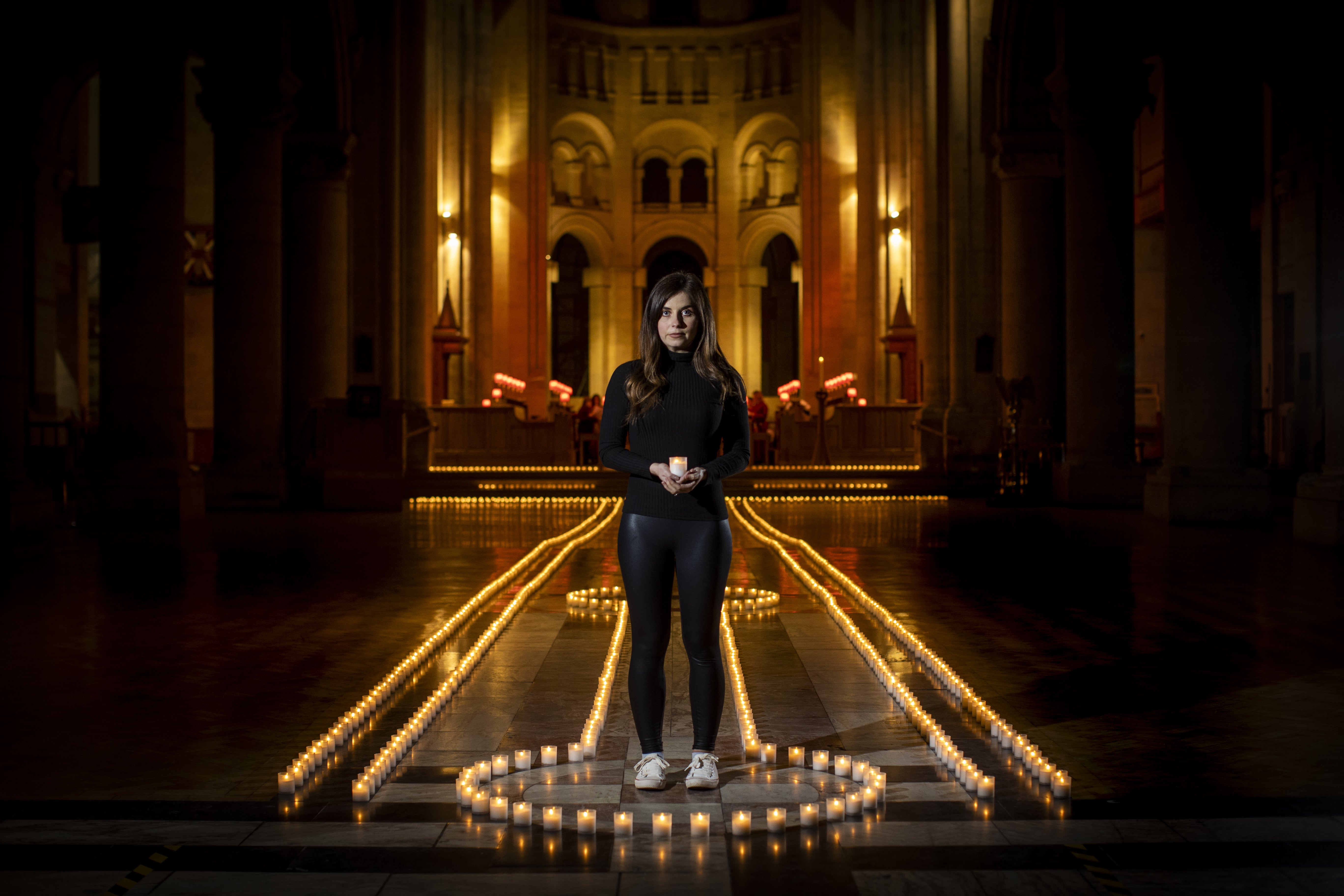 Holly Wilson, whose grandmother Ada Wilson died during the pandemic, stands in Belfast Cathedral before a remembrance service in partnership with Marie Curie for their National Day of Reflection (Liam McBurney/PA)