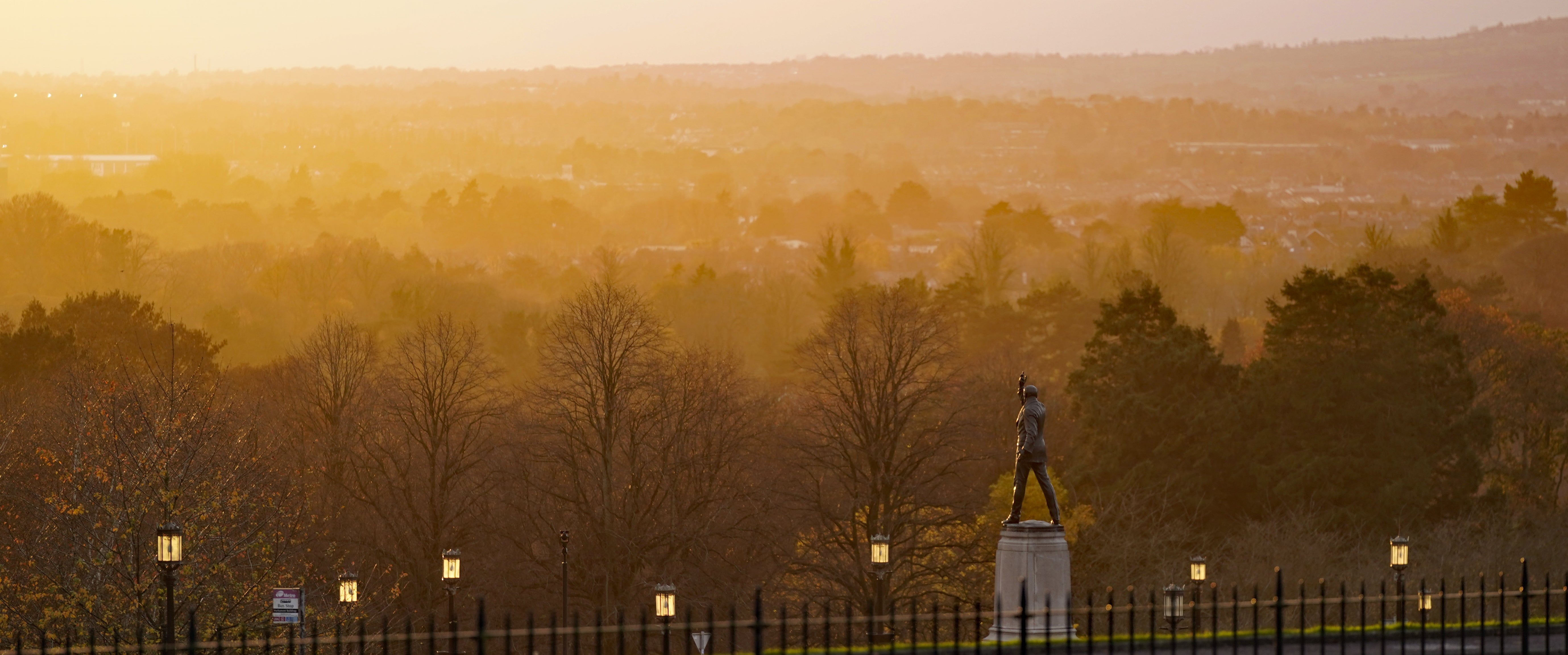 The sun sets over the Edward Carson statue at Stormont as the Northern Ireland Protocol negotiations continued (Niall Carson/PA)
