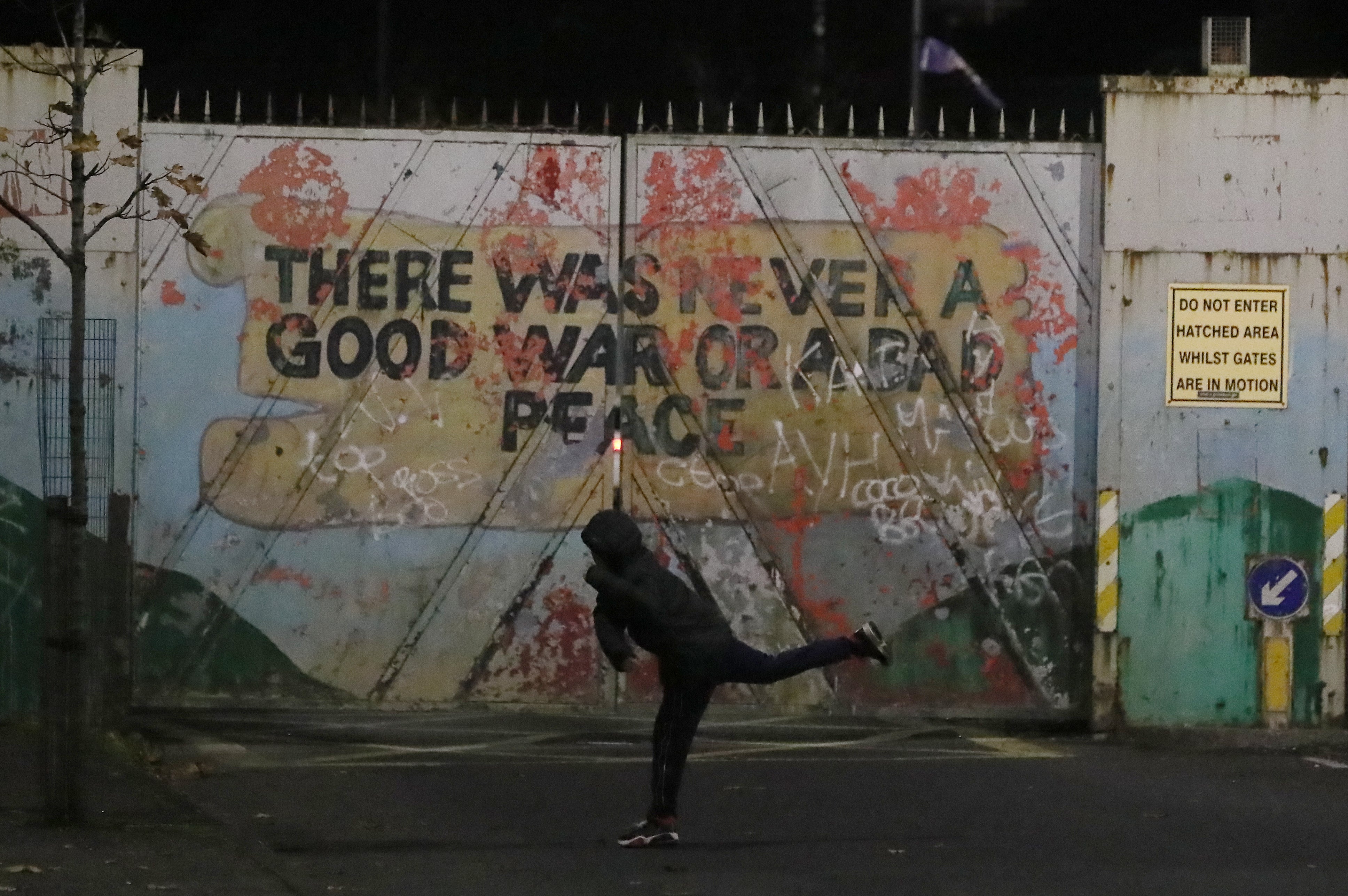 A protestor on Lanark Way in the Loyalist Shankill Road area close to the peace wall during a protest against the protocol in November (Brian Lawless/PA)