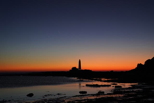 The blue hour before sunrise over St Mary’s Lighthouse in Whitley Bay off the North East coast. Picture date: Friday December 17, 2021.