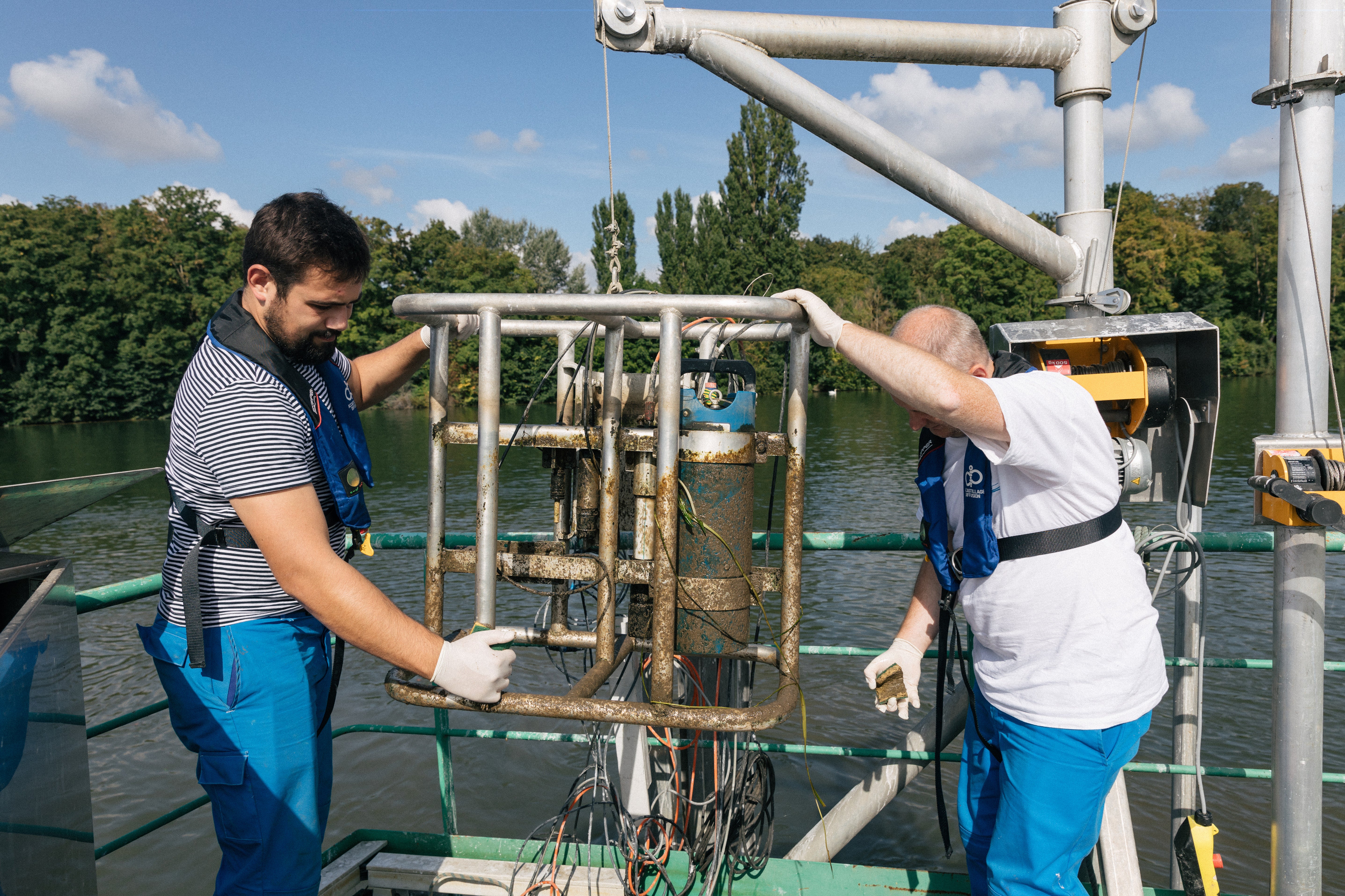 Erwan Garcia Gonzalez, right, and Robin Richoux Garcia clean the underwater tools that analyse water quality in Andresy
