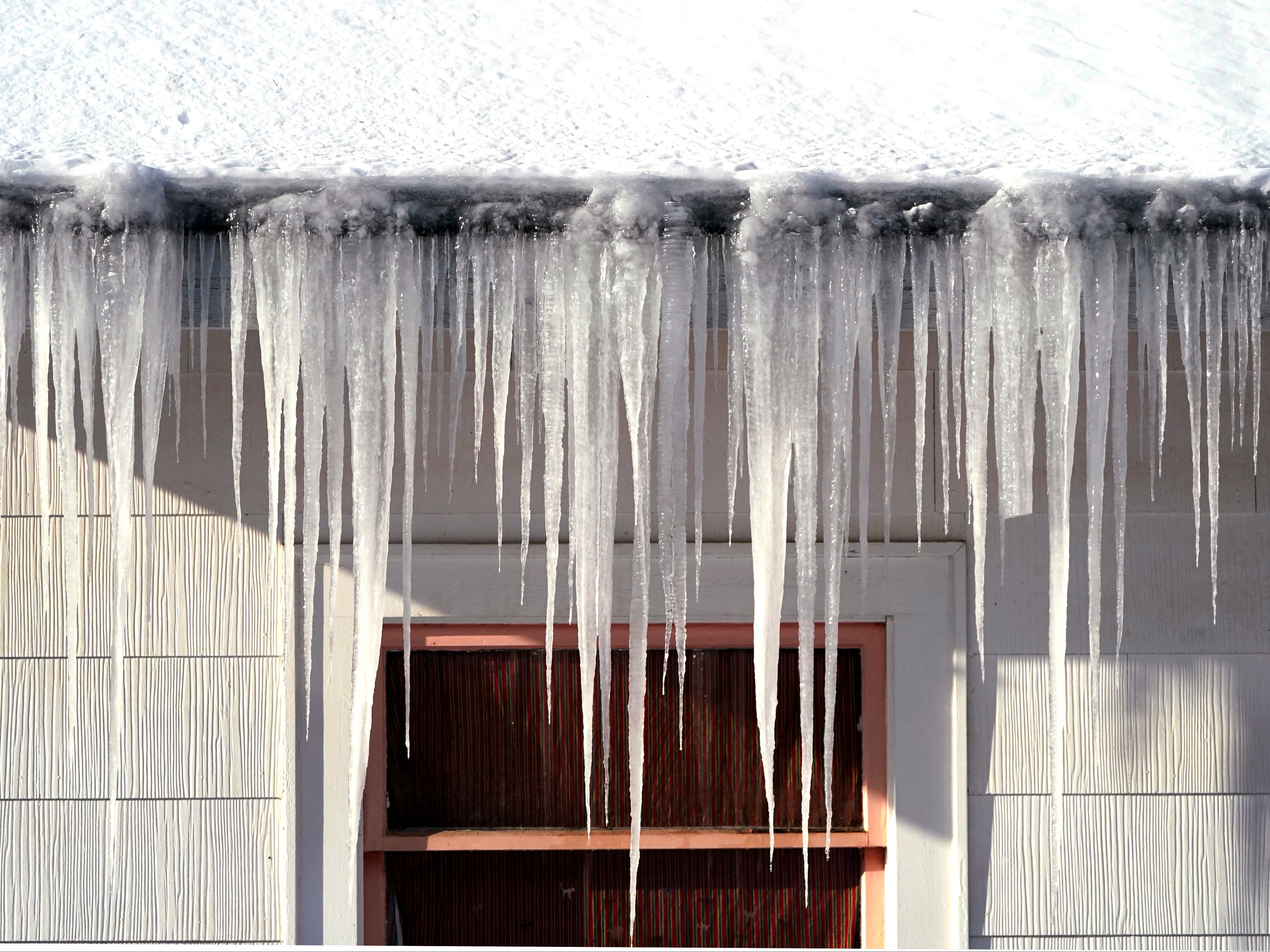 Long icicles hang from a house where nearly a foot of snow fell over the weekend, on Monday, December 27, in Bellingham, Alaska