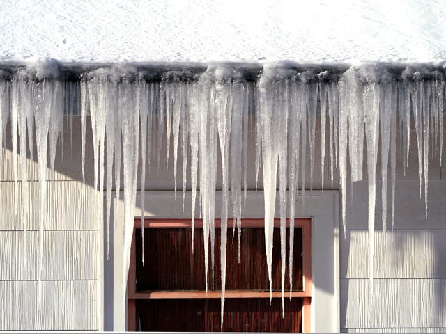 <p>Long icicles hang from a house where nearly a foot of snow fell over the weekend, on Monday, December 27, in Bellingham, Alaska</p>