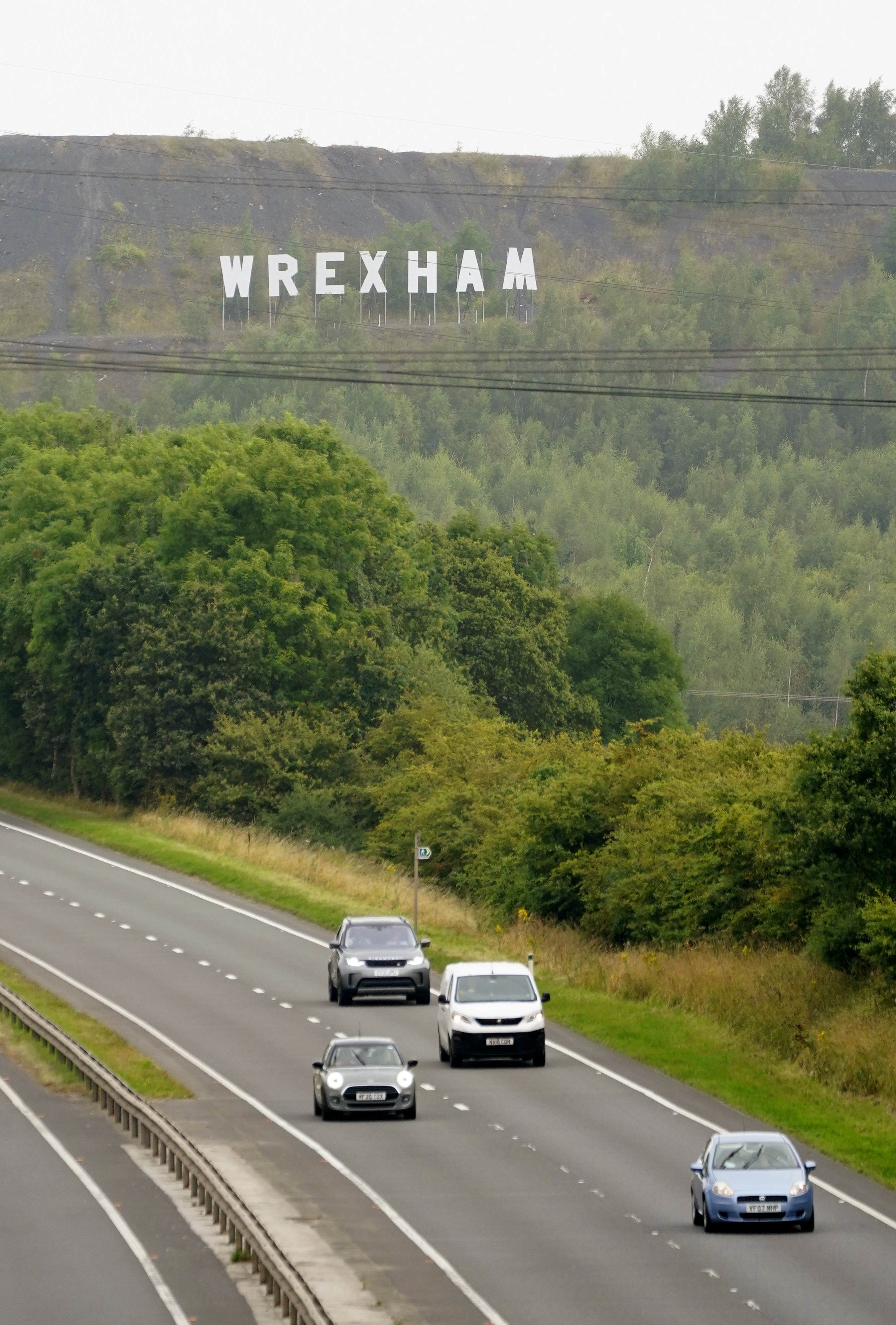 A large sign for Wrexham, in the style of the Hollywood sign in Los Angeles, installed on the Bursham Bank (Peter Byrne/PA)