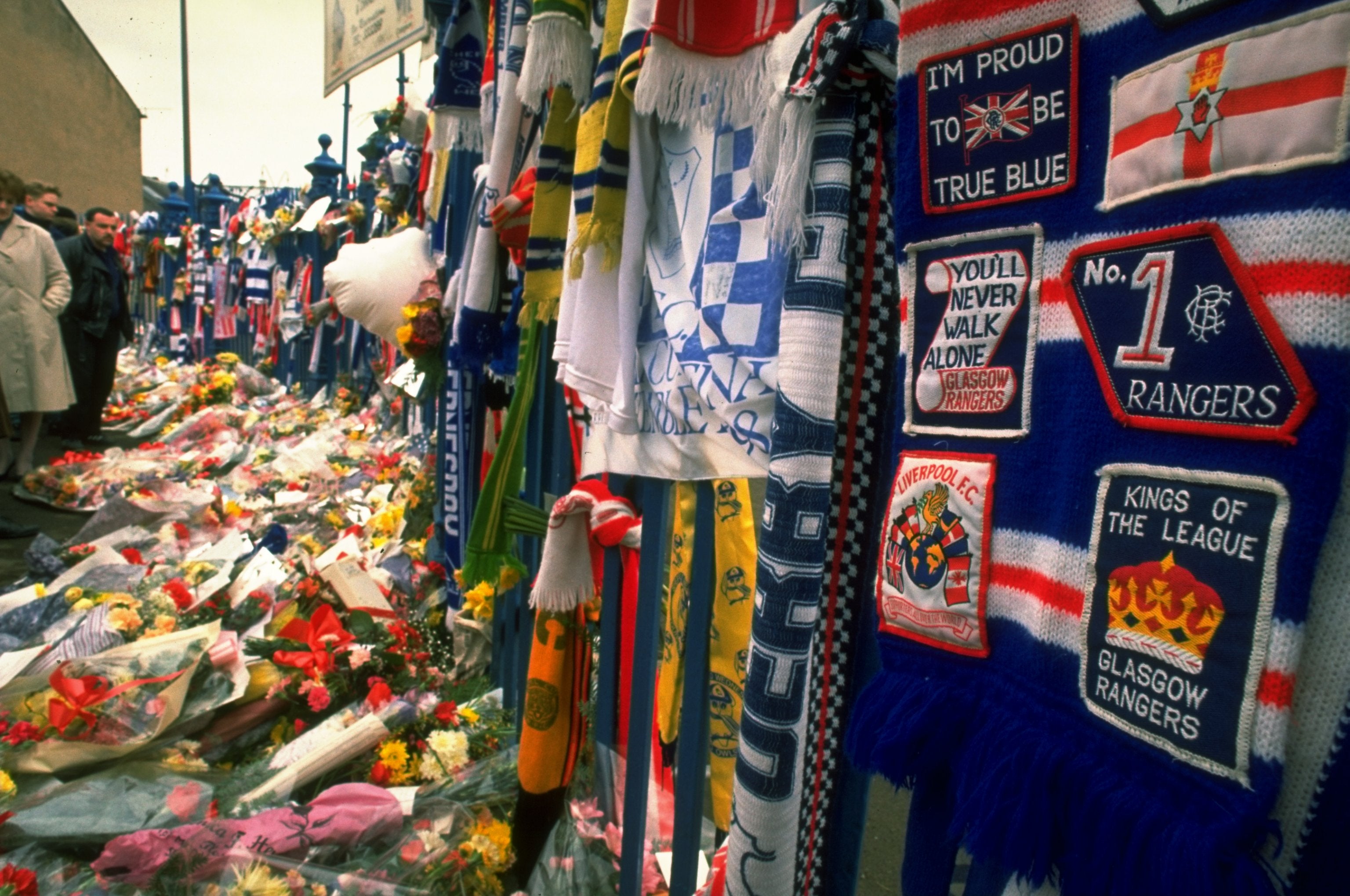 Tributes cover a fence and path outside the Sheffield Wednesday ground in the aftermath of the disaster