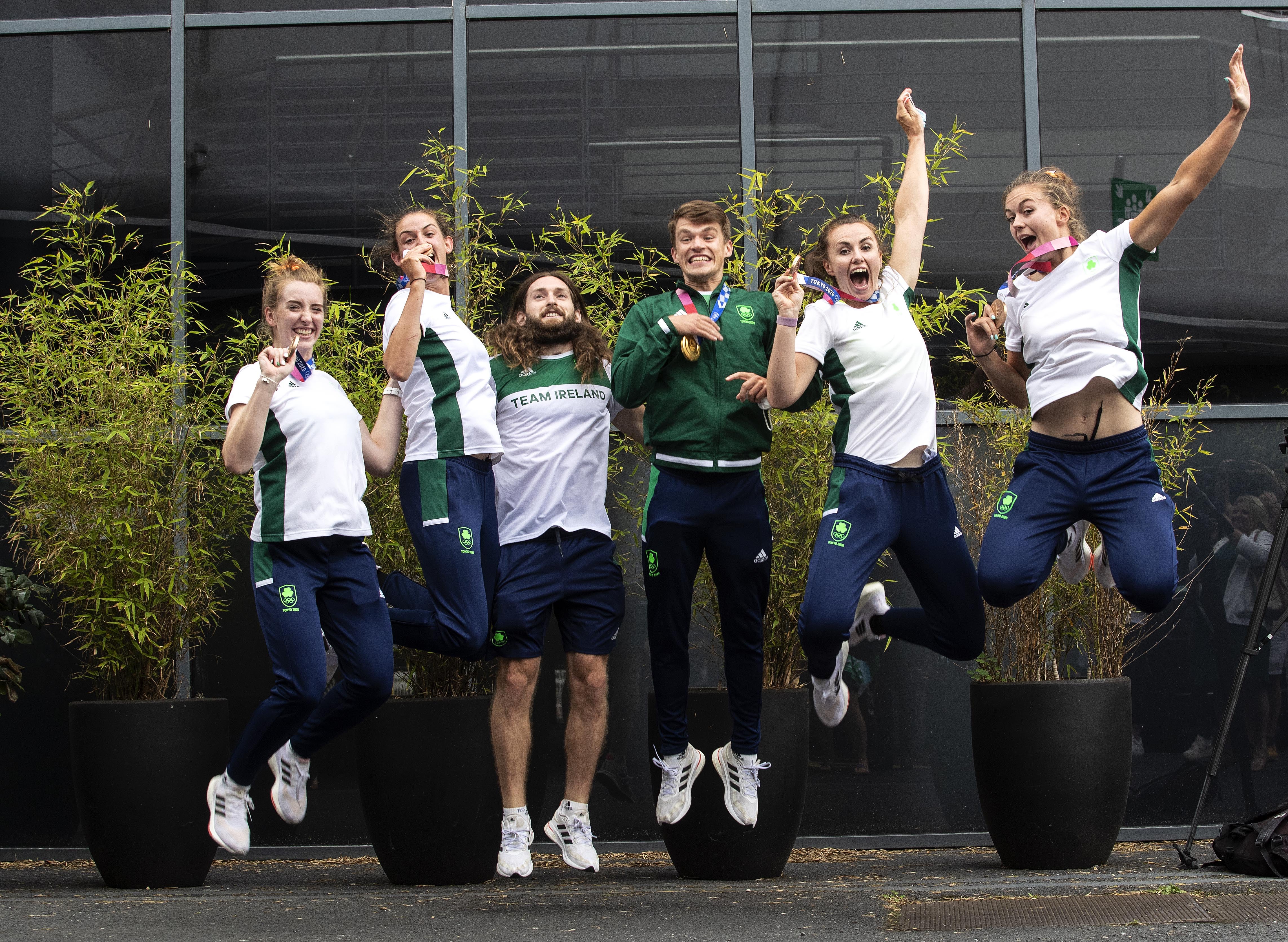 Irish rowers with their gold and bronze medals, left to right, Emily Hegarty, Fiona Murtagh, Paul O’Donovan, Fintan McCarthy, Aifric Keogh and Eimear Lambe, at Dublin Airport following their return from the Olympics (Damien Eagers/PA)