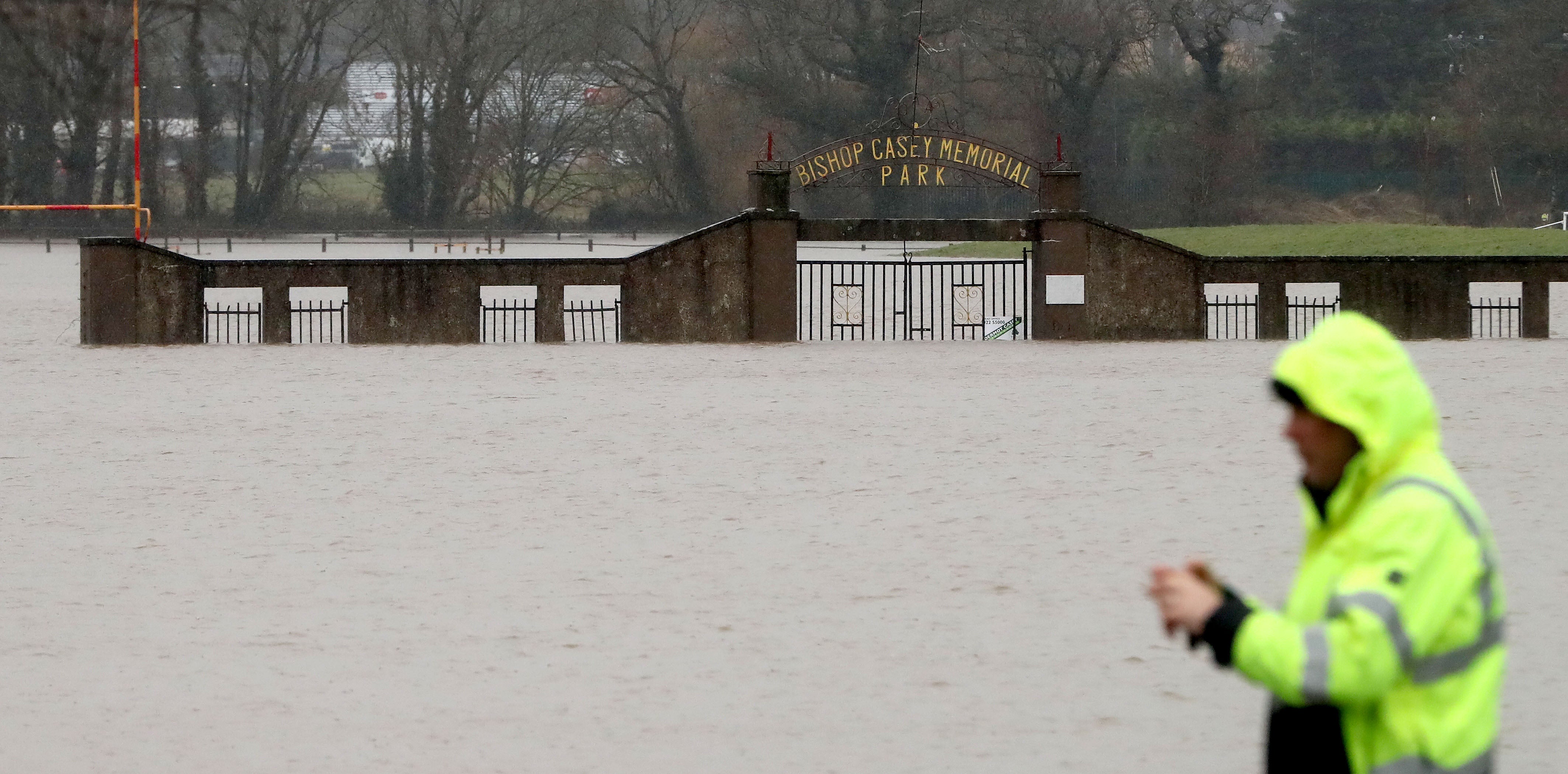 A man stops to take a picture of floodwater at the Bishop Casey Memorial Park in Mallow, Co Cork, after the River Blackwater burst its banks (Niall Carson/PA)