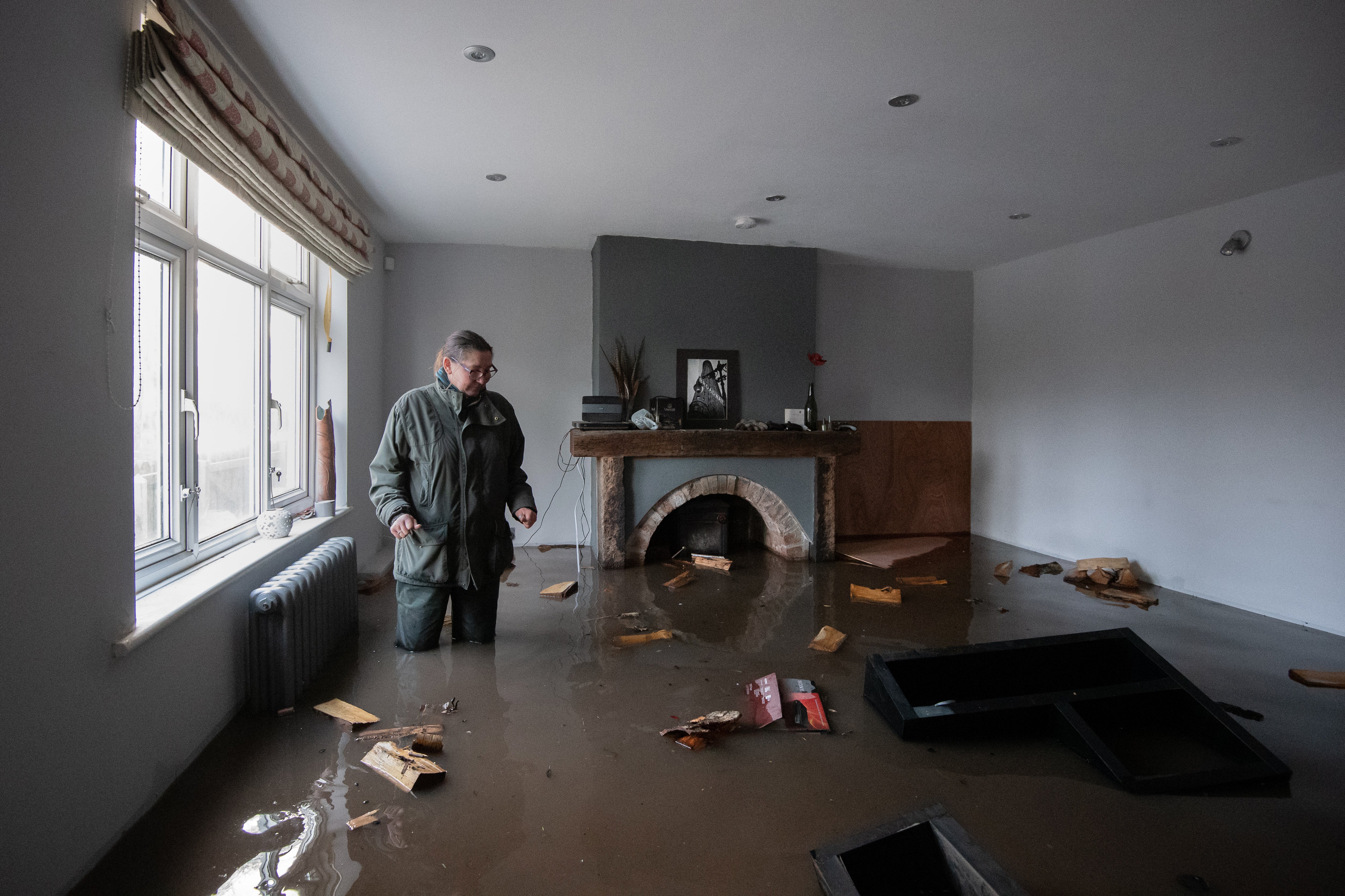 Gabrielle Burns-Smith in her flooded home on the outskirts of Lymm in Cheshire as Storm Christoph causes widespread flooding across the UK