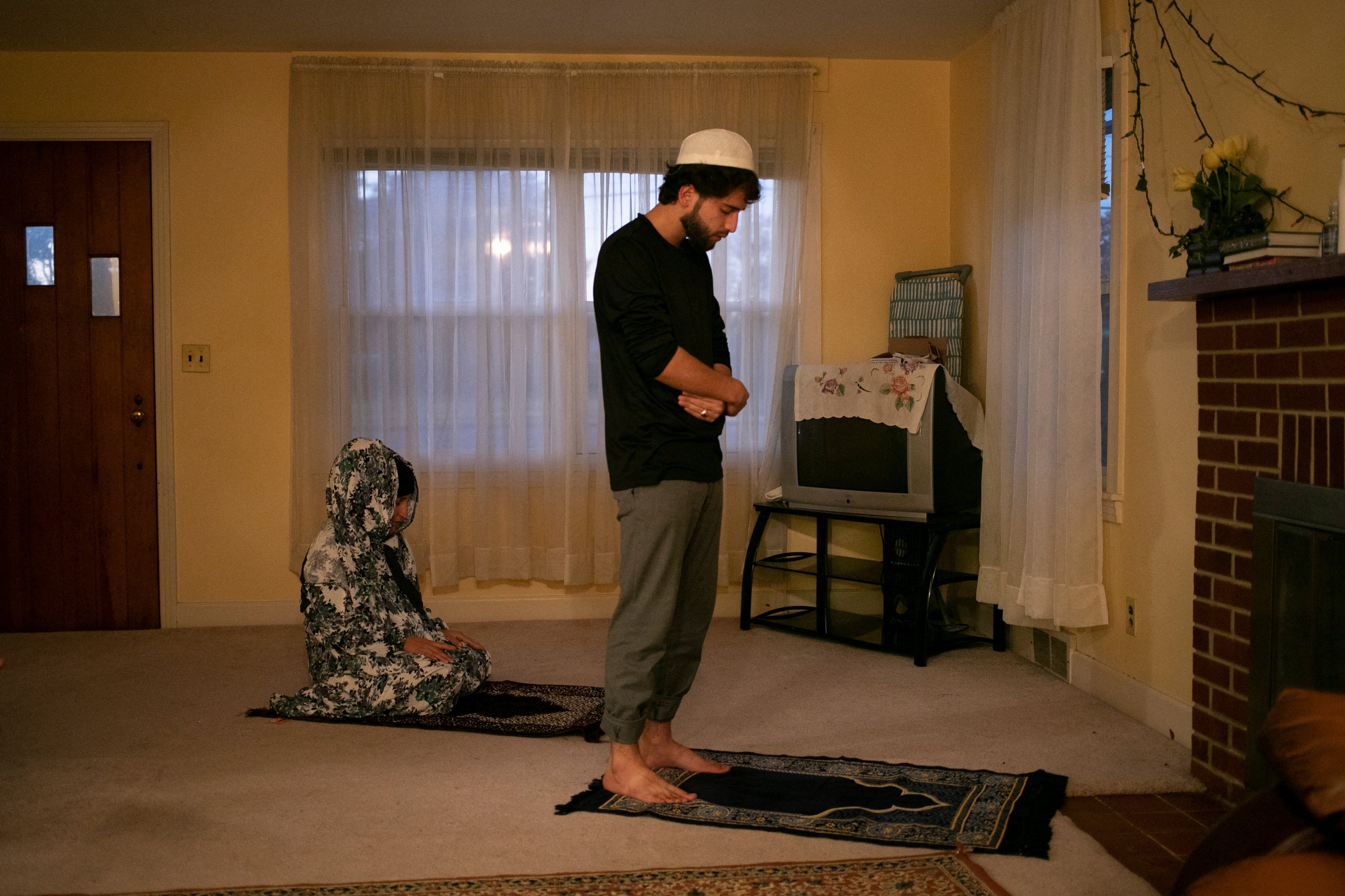 Mohamed Azizi prays with his aunt Wahida Habibi in Bowling Green, Kentucky