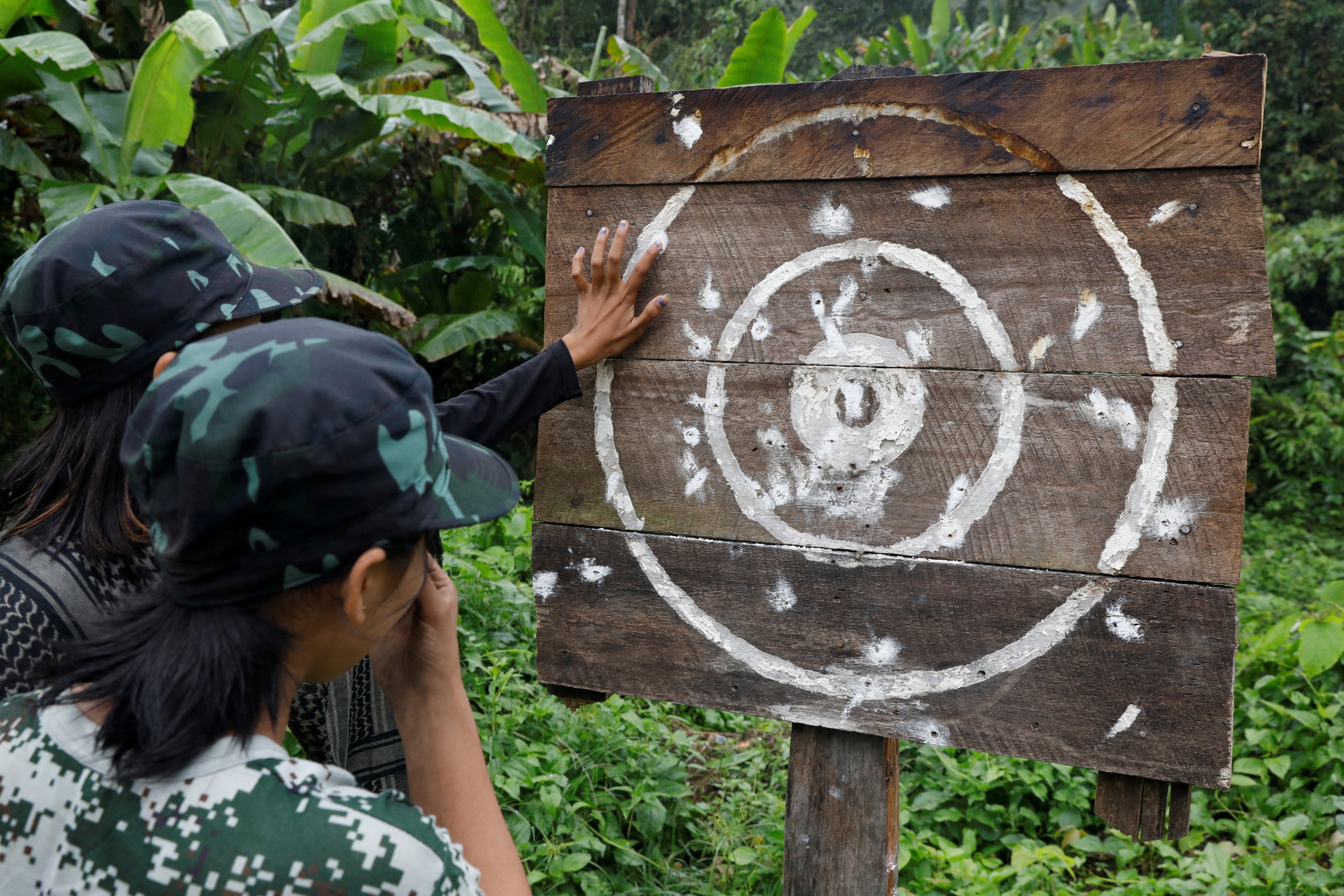 PDF recruits inspect a target during shooting practice