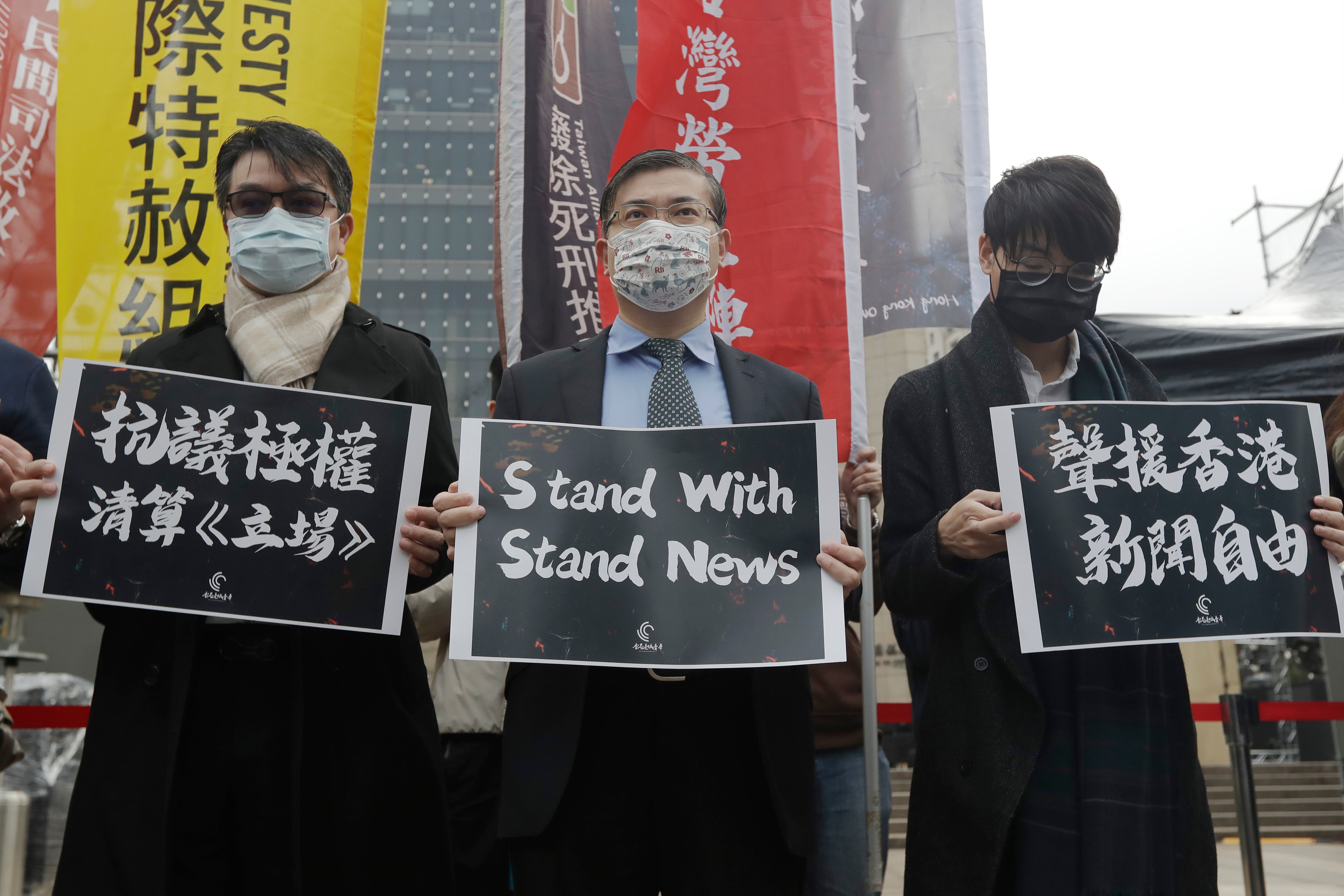 Protesters from Hong Kong in Taiwan and local supporters hold slogans reading ‘Protest Against Totalitarian Liquidation of Stand News’ and ‘Support Press Freedom in Hong Kong’