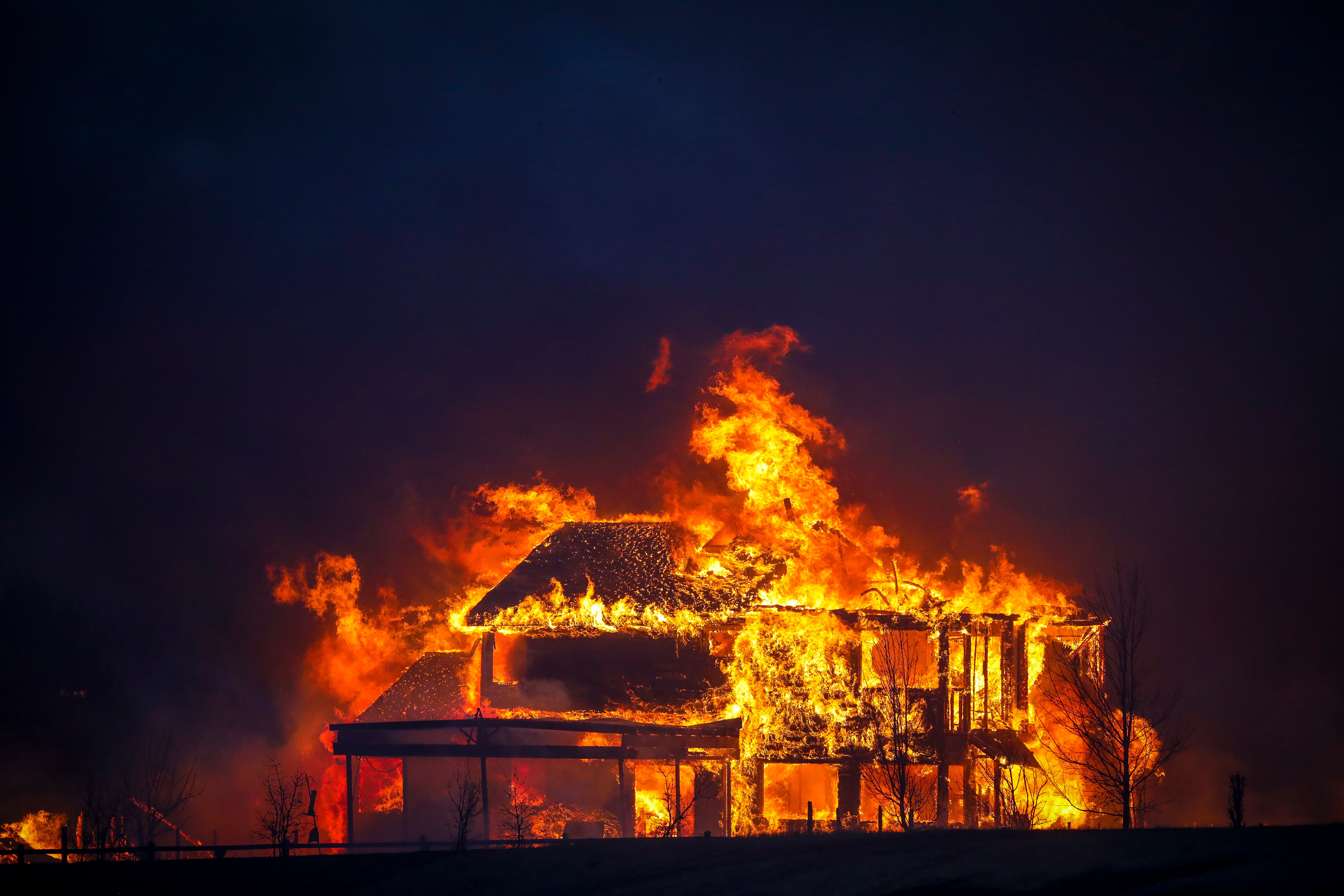 A home burns after a wildfire swept through Louisville, Colorado