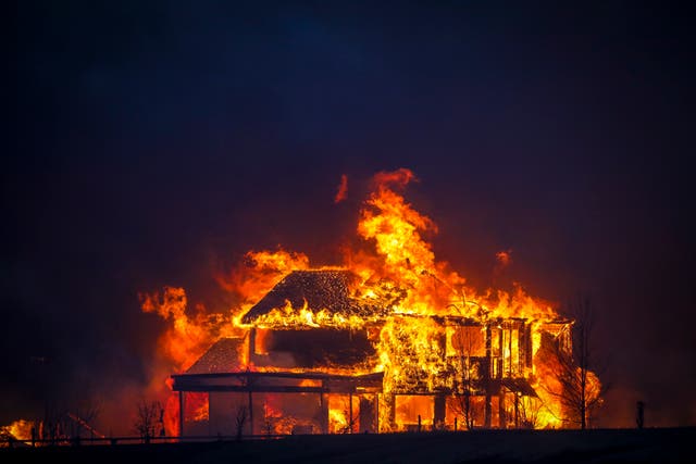 <p> A home burns after a wildfire swept through Louisville, Colorado</p>