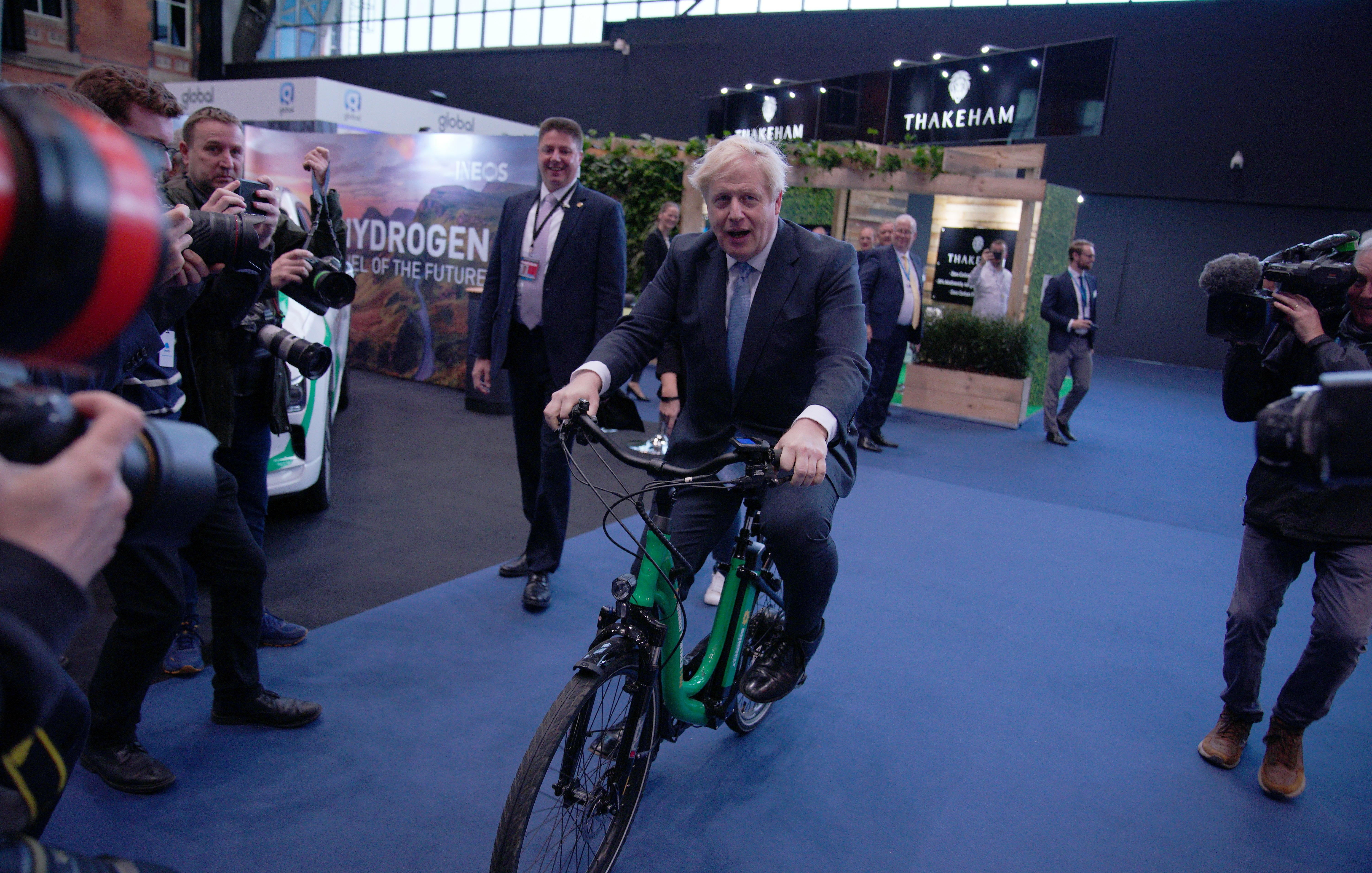 A rare moment of levity in 2021 for Mr Johnson as he rides a bicycle in the Manchester Central Convention Complex during the Conservative Party Conference (Peter Byrne/PA)