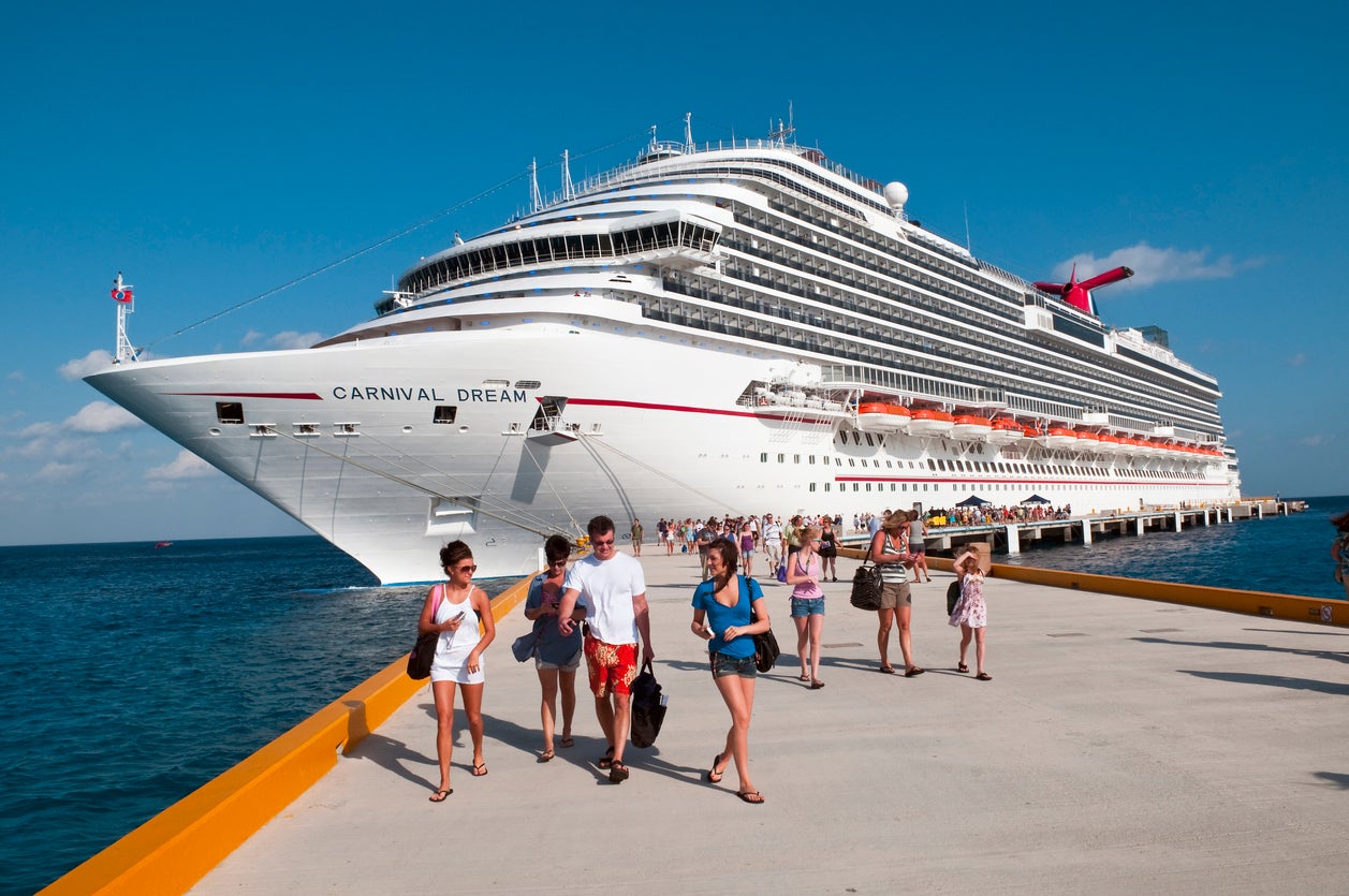Passengers disembark a cruise ship