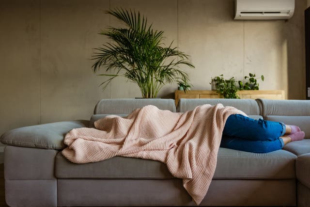 <p>A person with a hangover covered by a blanket</p>
