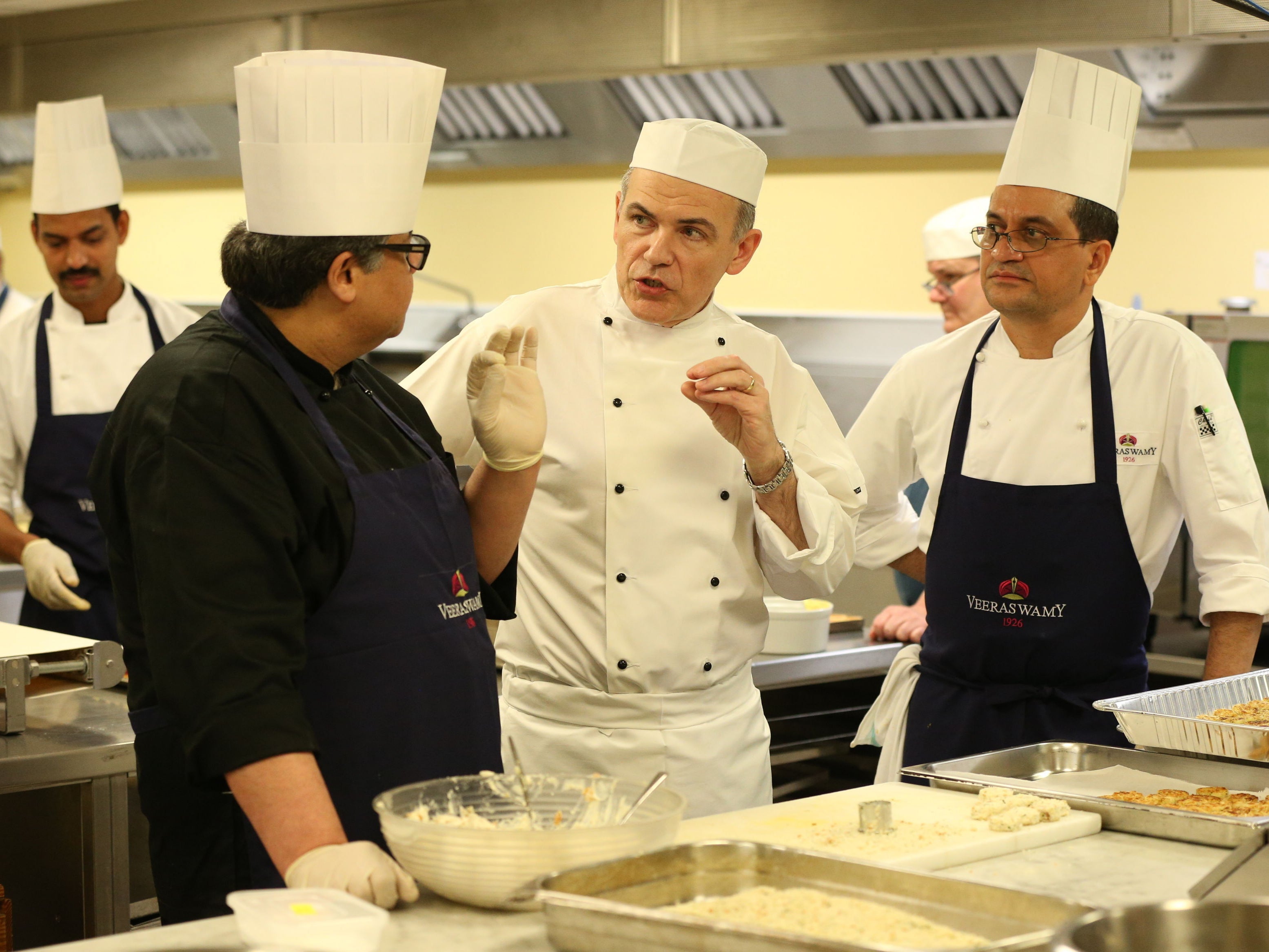 Head Chef Mark Flanagan (centre) and chef Uday Salumkhe (left) in the kitchen at Buckingham Palace as they prepare food for a reception to mark the launch of the UK-India Year of Culture 2017