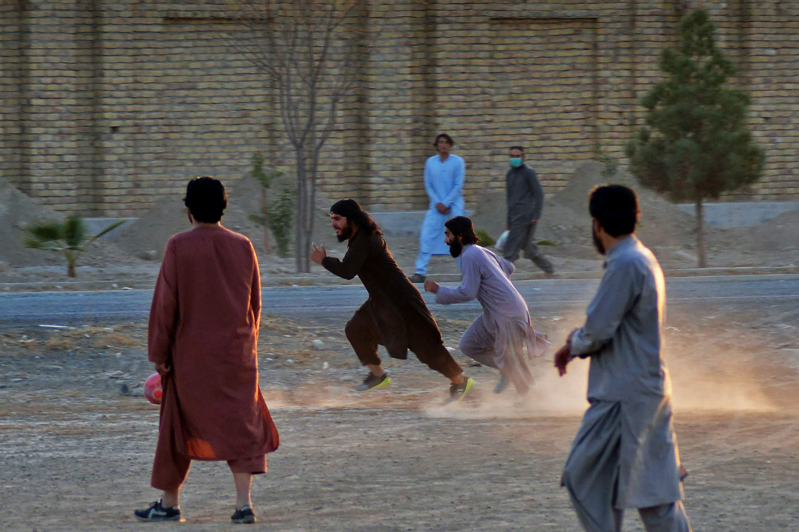 Taliban members play football at an amusement park in Kandahar on December 30, 2021
