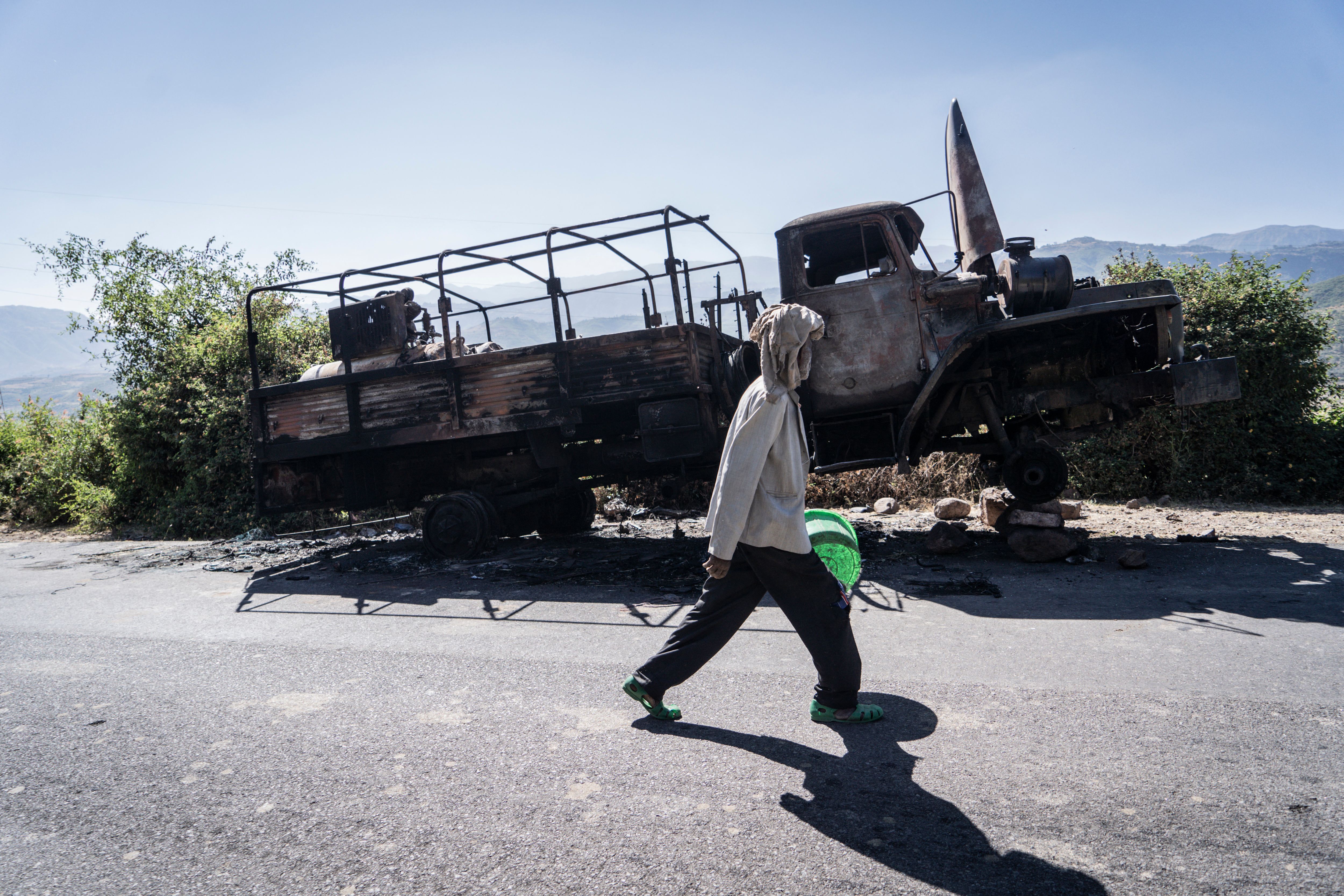 A man walks past a destroyed military truck in Karakore last month