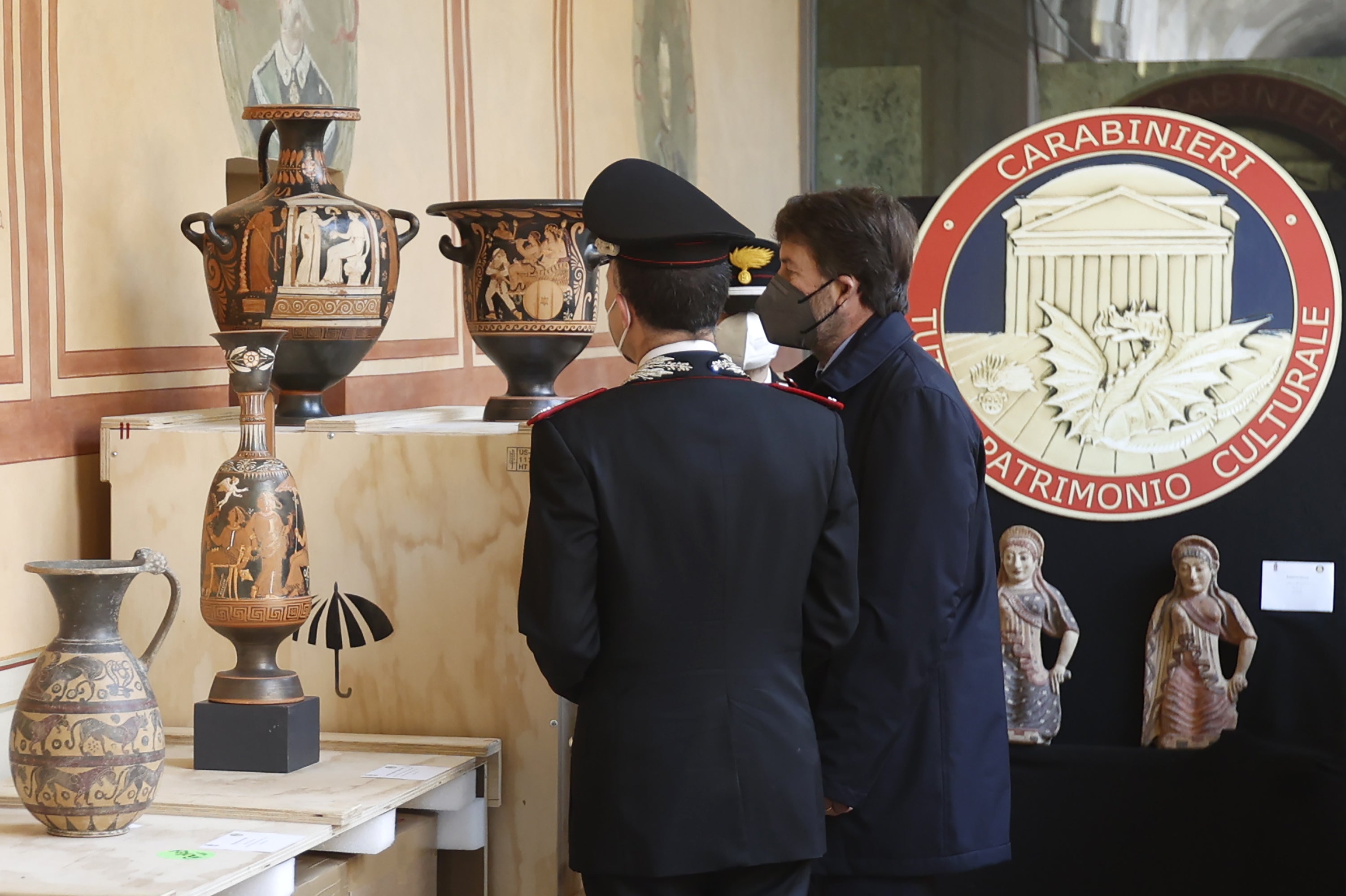 Italian Culture Minister Dario Franceschini (R) and Head of the Carabinieri Command for the Protection of Cultural Heritage Roberto Riccardi (L) inspect the findings resulting from the fight against illegal trafficking of cultural assets