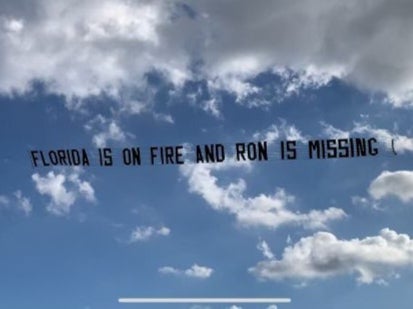 A plane tows a banner trolling Ron DeSantis