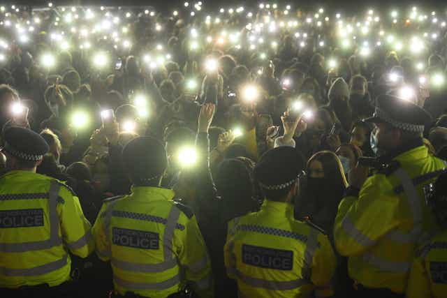 People in the crowd turn on their phone torches at the vigil for Sarah Everard (Victoria Jones/PA)