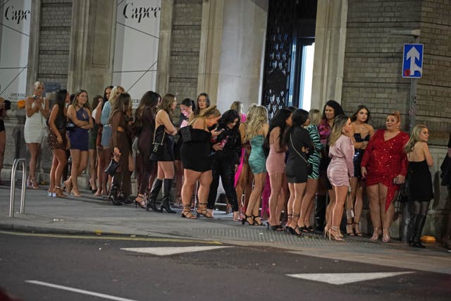 Revellers queue outside a nightclub in Liverpool (Peter Byrne/PA)