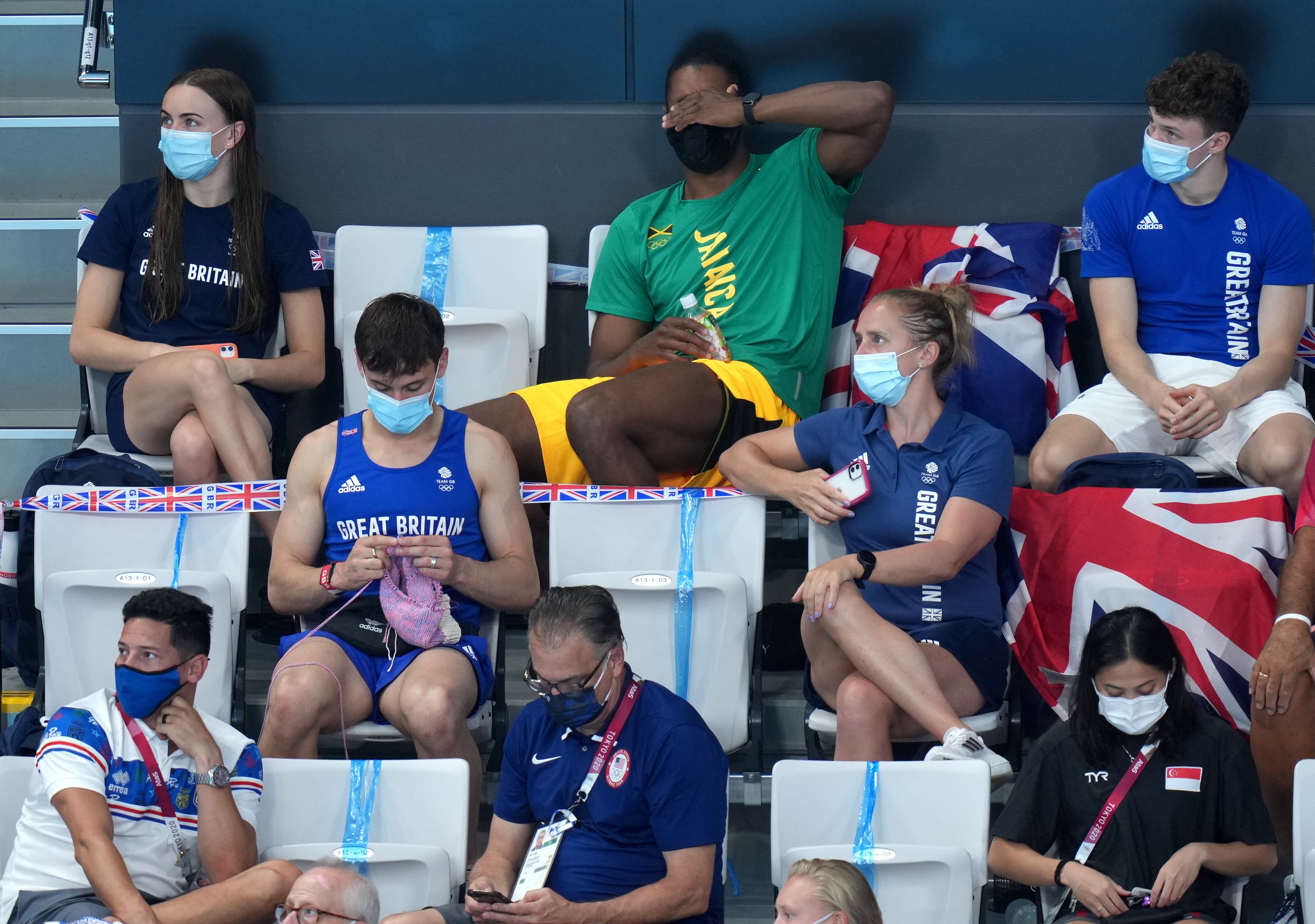 Tom Daley knits in the stands during the women’s 3m springboard final at the Tokyo Olympics (Joe Giddens/PA Images).