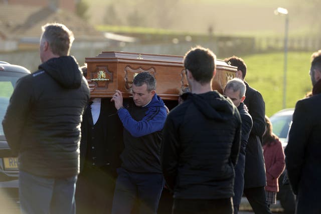 The coffin of Peter Alexander Finnegan being carried into St Patrick’s Church, Clogher, Co Tyrone (Oliver McVeigh/PA)