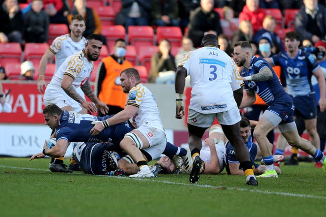 <p>Rohan Janse van Rensburg dives over the line to score a try for Sale Sharks </p>