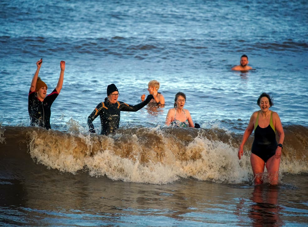 Swimmers take part in the New Year’s Day swim at Derby Pool, New Brighton, Wirral (PA)