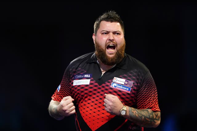 Michael Smith celebrated a memorable win over the world number one at Alexandra Palace (Zac Goodwin/PA)