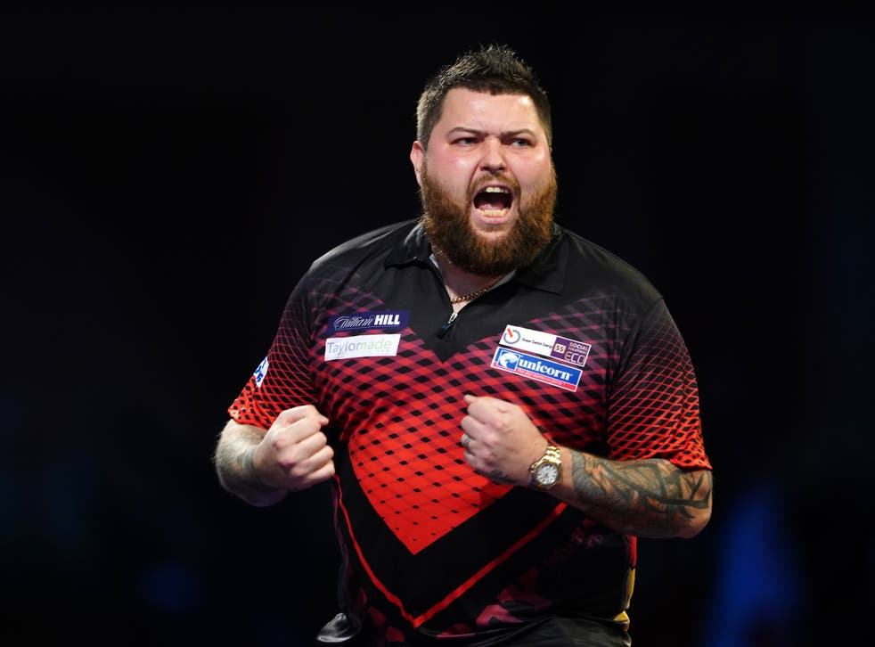 Michael Smith celebrated a memorable win over the world number one at Alexandra Palace (Zac Goodwin/PA)