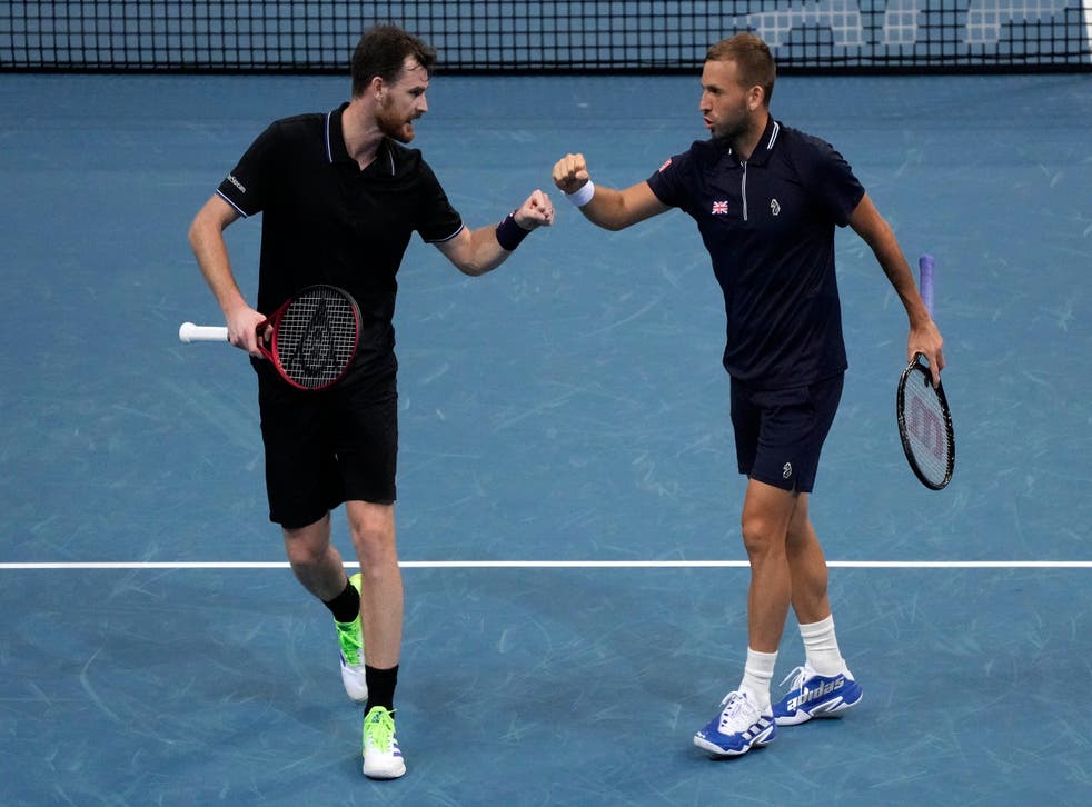 Dan Evans, right, and Jamie Murray celebrate victory in the ATP Cup (Rick Rycroft/AP)
