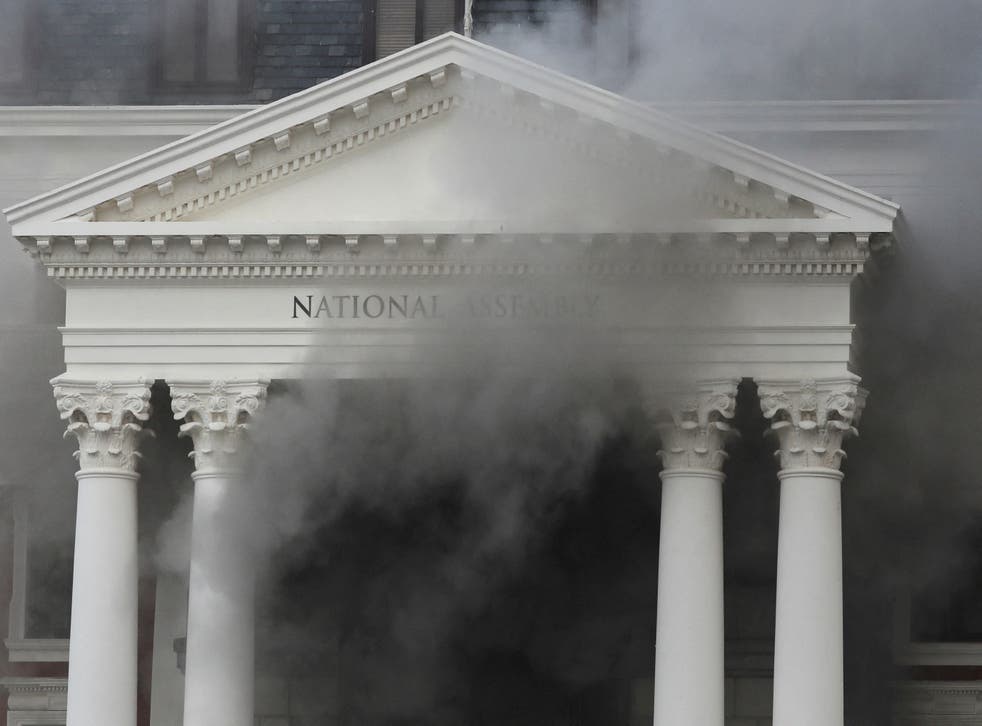 <p>Smoke rises after a fire broke out at the parliament building in Cape Town</p>
