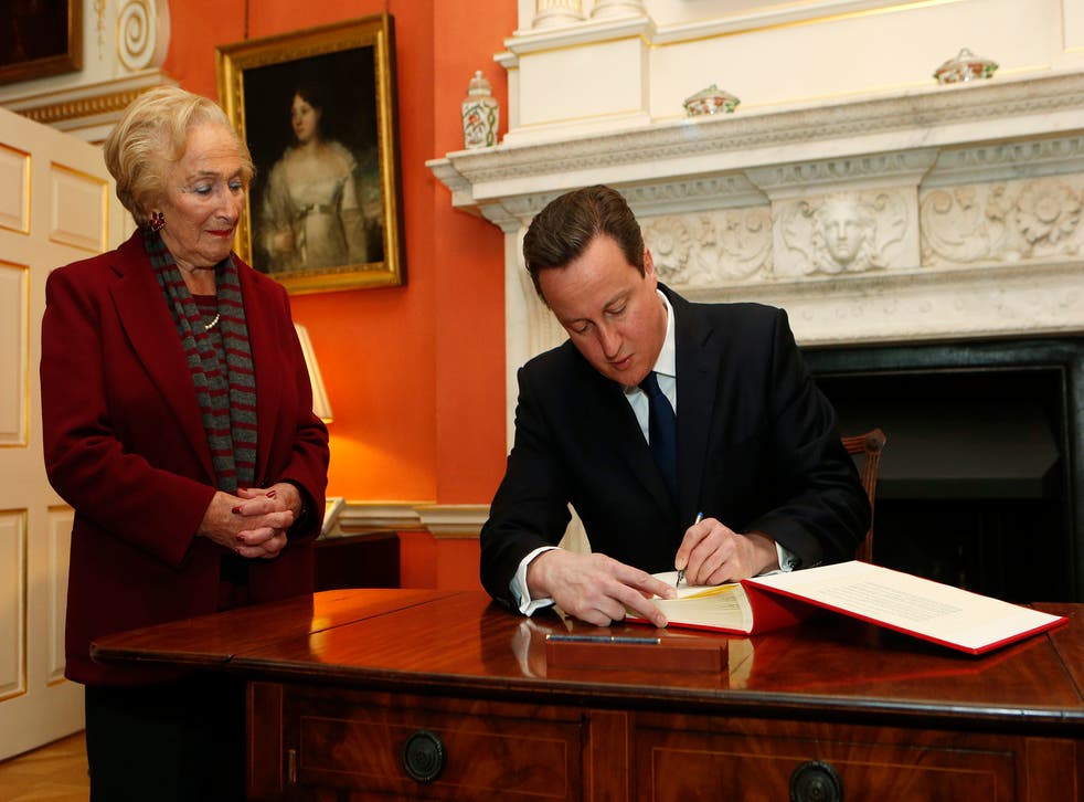 Prime Minister David Cameron signs the Book of Commitment ahead of Holocaust Memorial Day as Holocaust survivor Freda Wineman watches at 10 Downing Street in London (Suzanne Plunkett/PA)