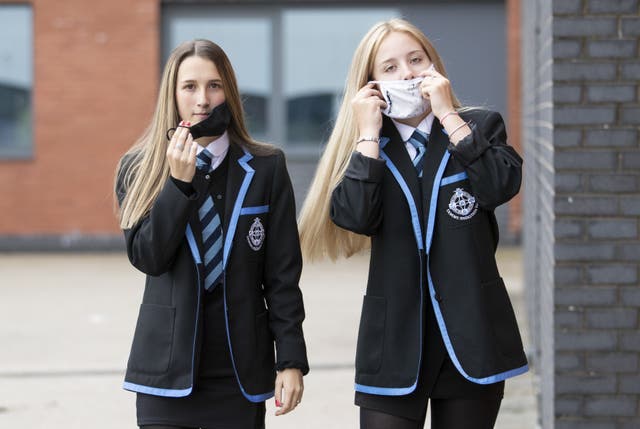 Leah McCallum (left) and Rebecca Ross, S4 students at St Columba’s High School, Gourock, put on their protective face masks as the requirement for secondary school pupils to wear face coverings when moving around school comes into effect from today across Scotland.