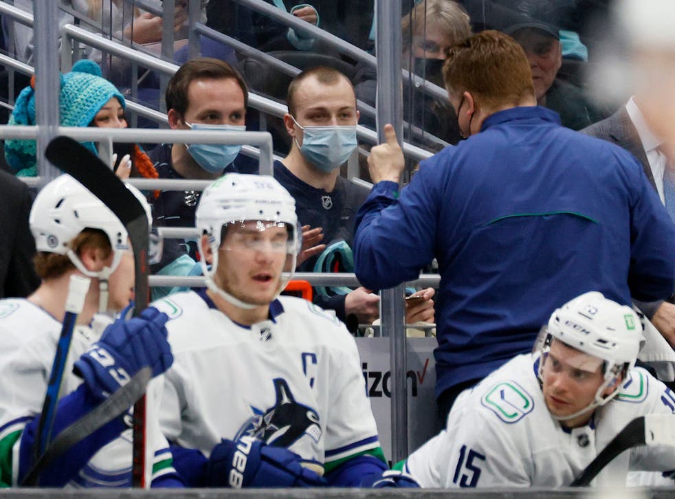 <p>Seattle Kraken fan Nadia Popovici and Vancouver Canucks equipment manager Brian Hamilton greet one another during the first period at Climate Pledge Arena on 1 January 2022 in Seattle, Washington. Popovici made headlines by alerting Hamilton at a previous game between the teams on 23 October of a cancerous mole</p>