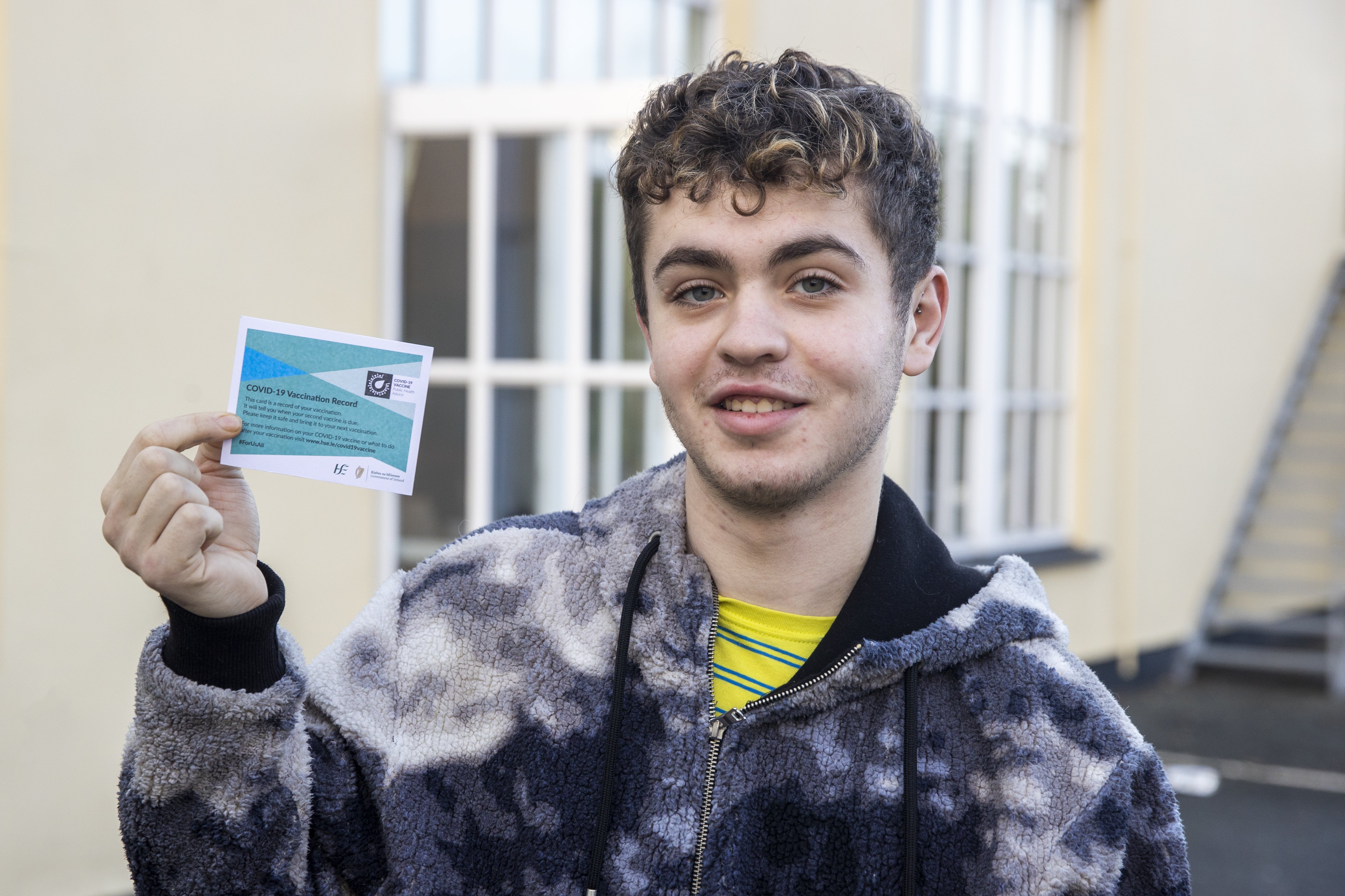 Ross Mshanen holds his Covid-19 Vaccination Record card at the Glencarn Hotel, Co Monaghan (Liam McBurney/PA)