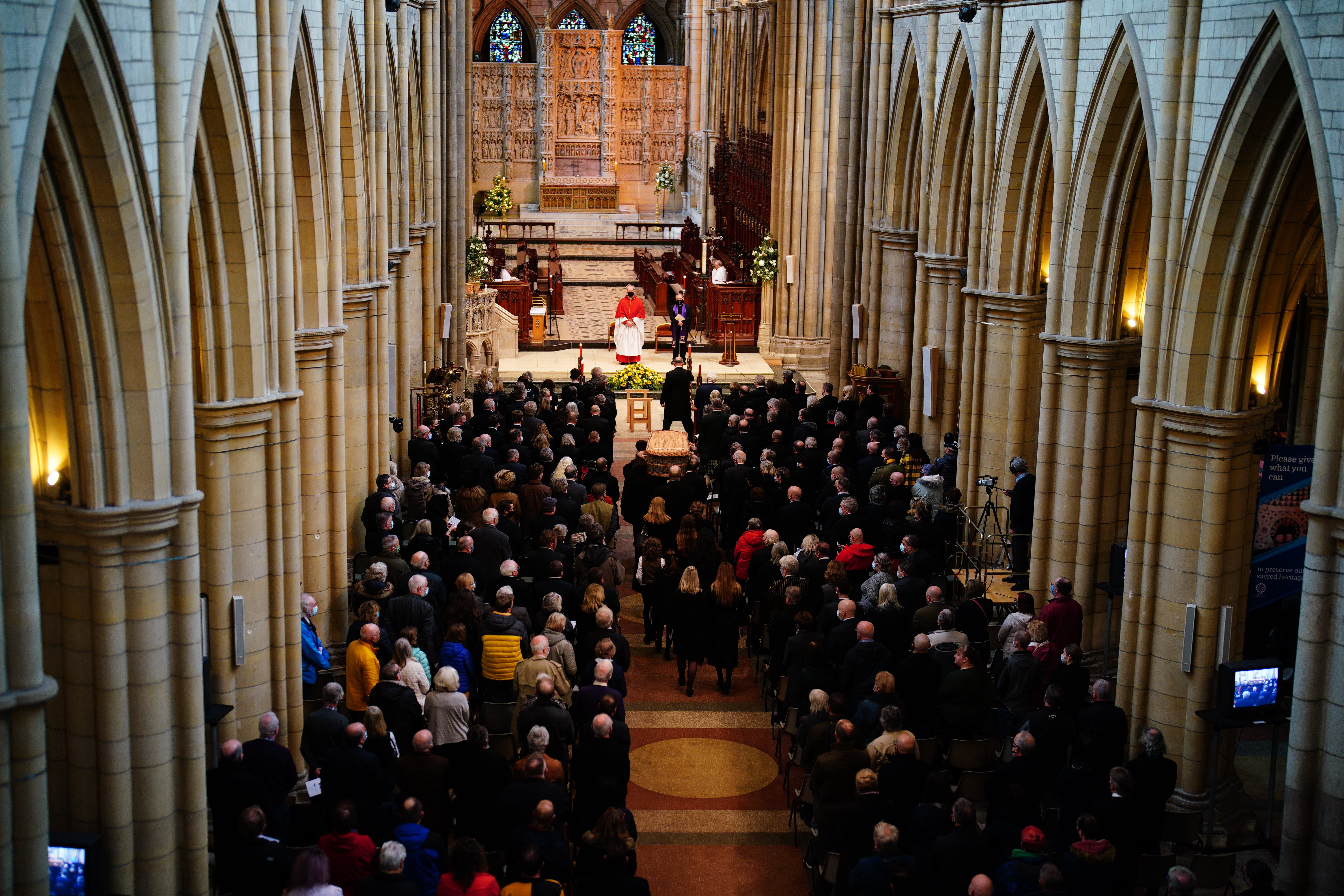 The coffin is carried into the funeral service of Cornish comedian Jethro at Truro Cathedral in Cornwall. Jethro, real name Geoffrey Rowe, died on December 14 after contracting Covid-19 (Ben Birchall/PA)