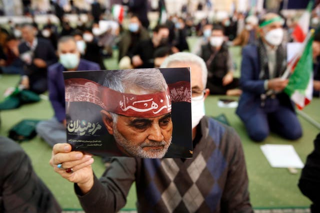 <p>Iranians hold pictures of Qasem Soleimani during a ceremony marking the second anniversary of the death of the Iranian Revolutionary Guards Corps’ lieutenant general and commander</p>