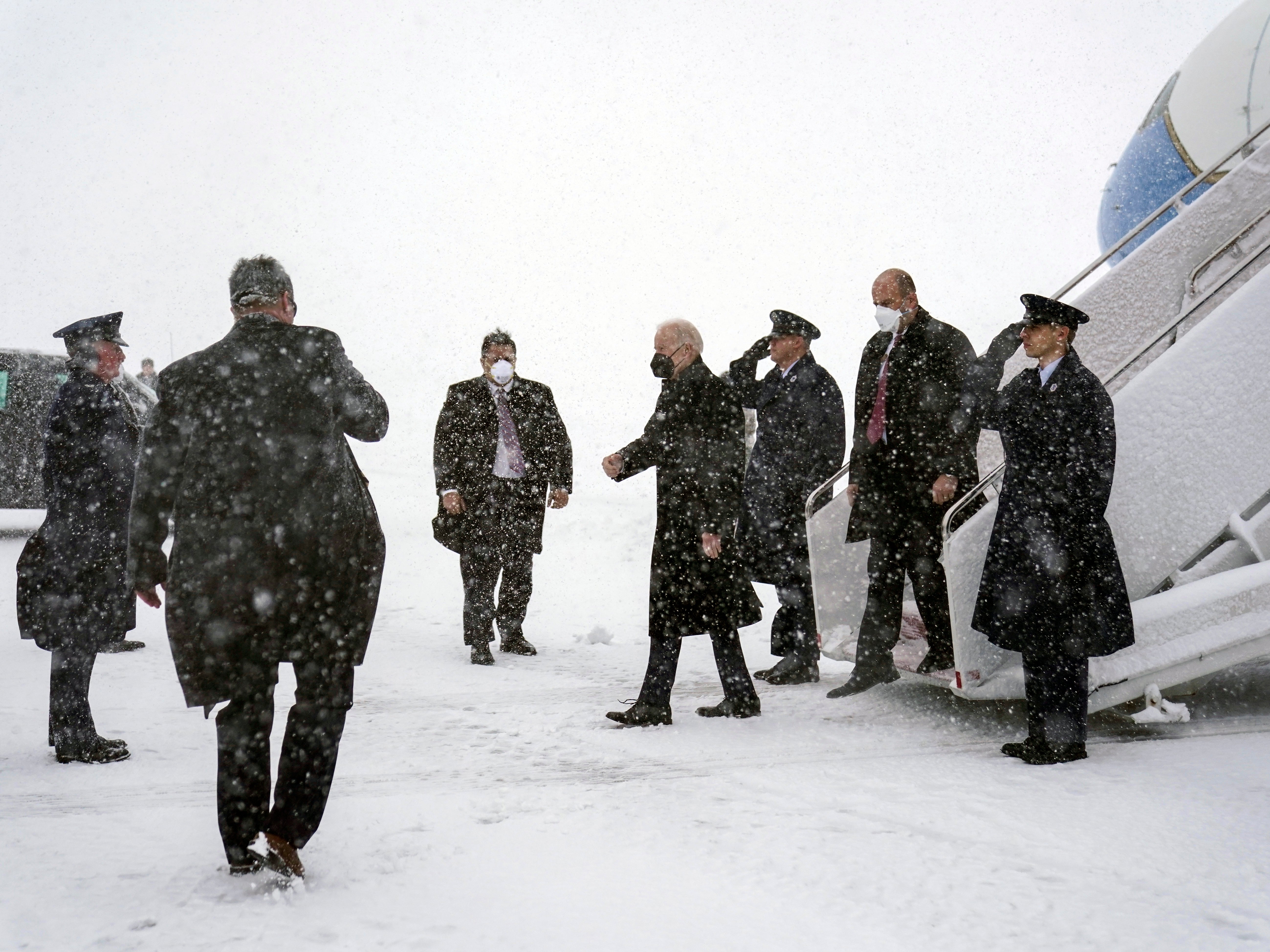 President Joe Biden arrives on Air Force One during winter snowstorm at Andrews Air Force Base, Md., Monday, Jan. 3, 2022, en route to Washington