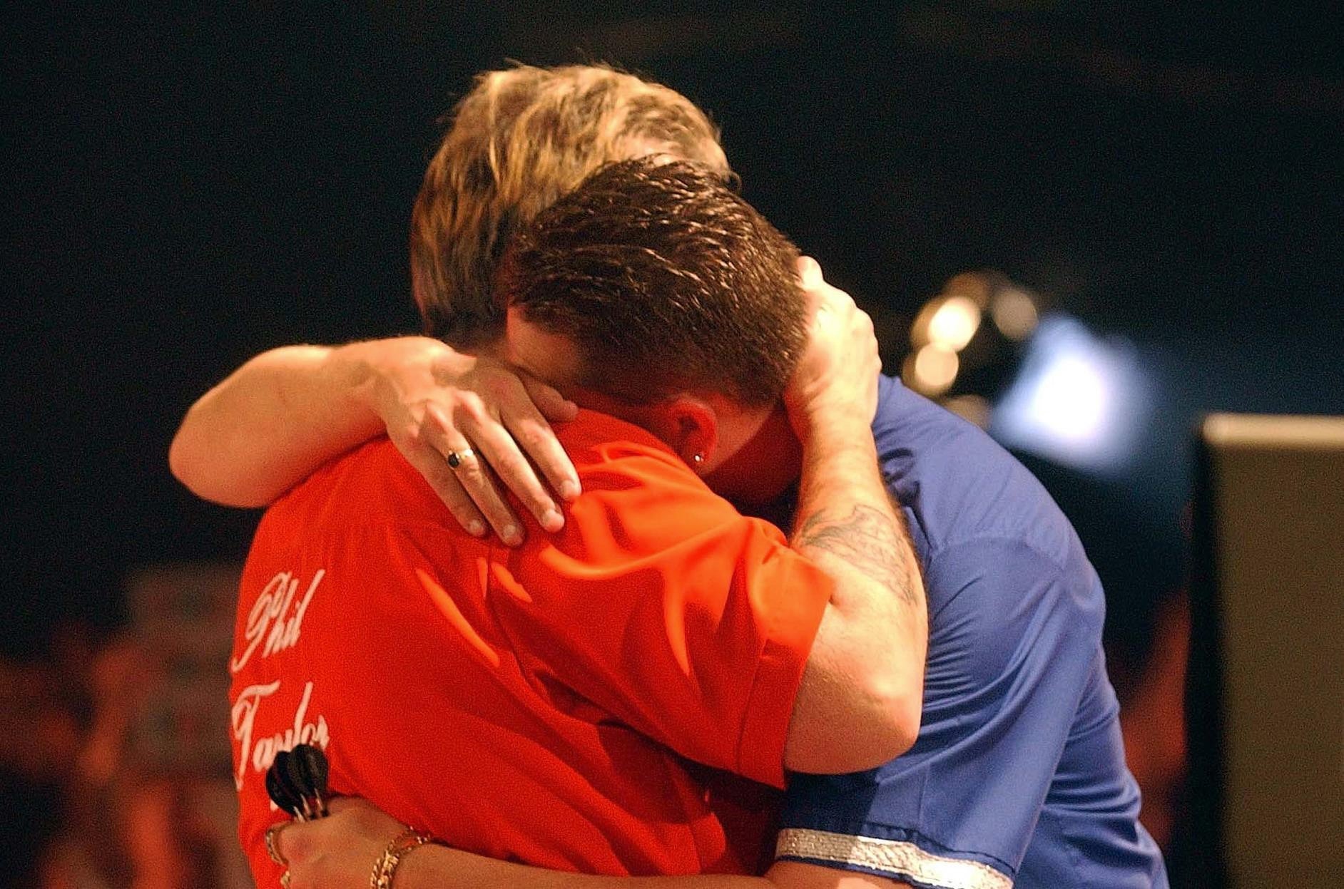 Phil Taylor consoles Kevin Painter after their epic contest (Sean Dempsey/PA)