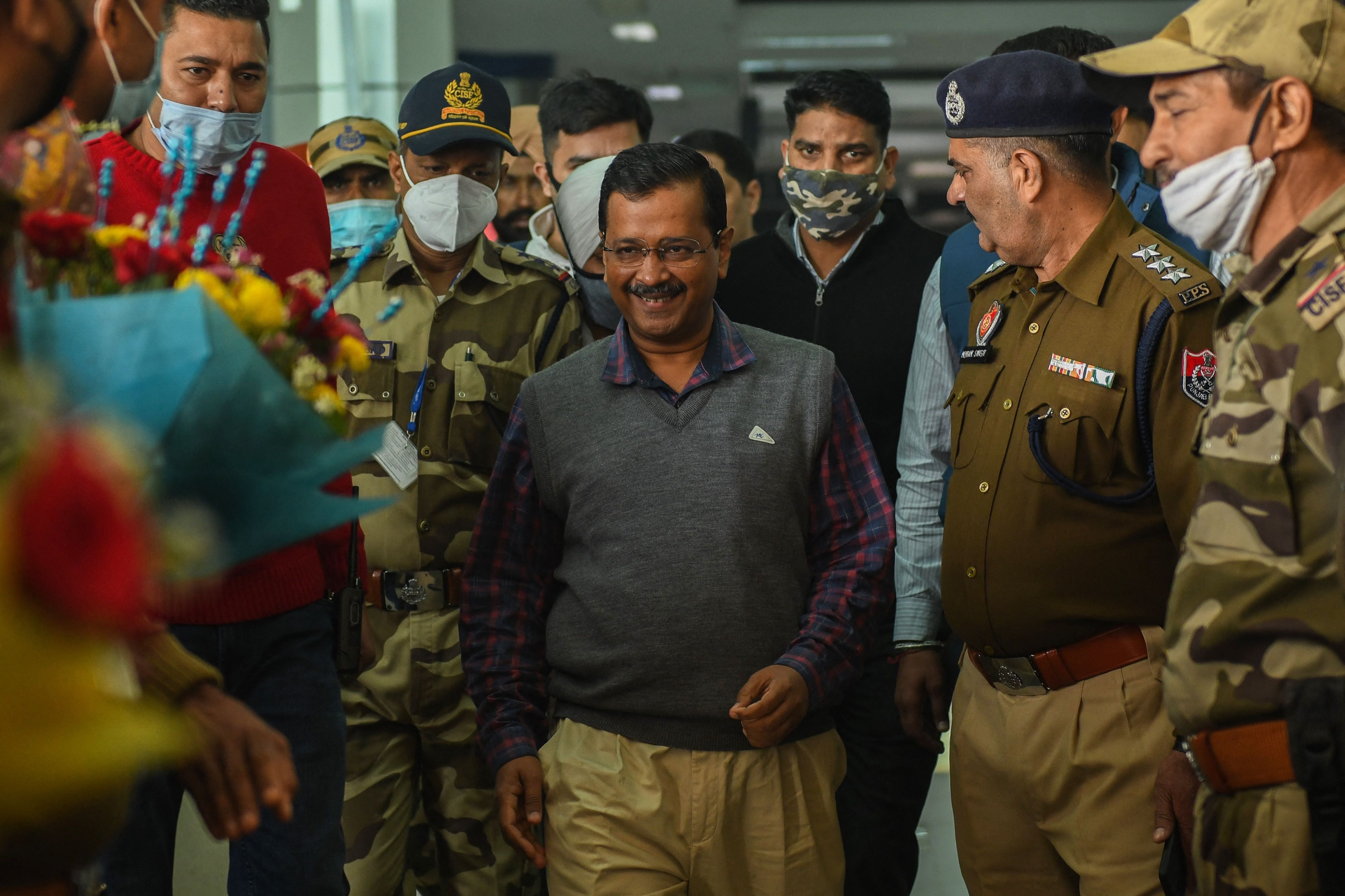 Delhi's chief minister Arvind Kejriwal (centre) is greeted upon his arrival ahead of a political rally in December 2021