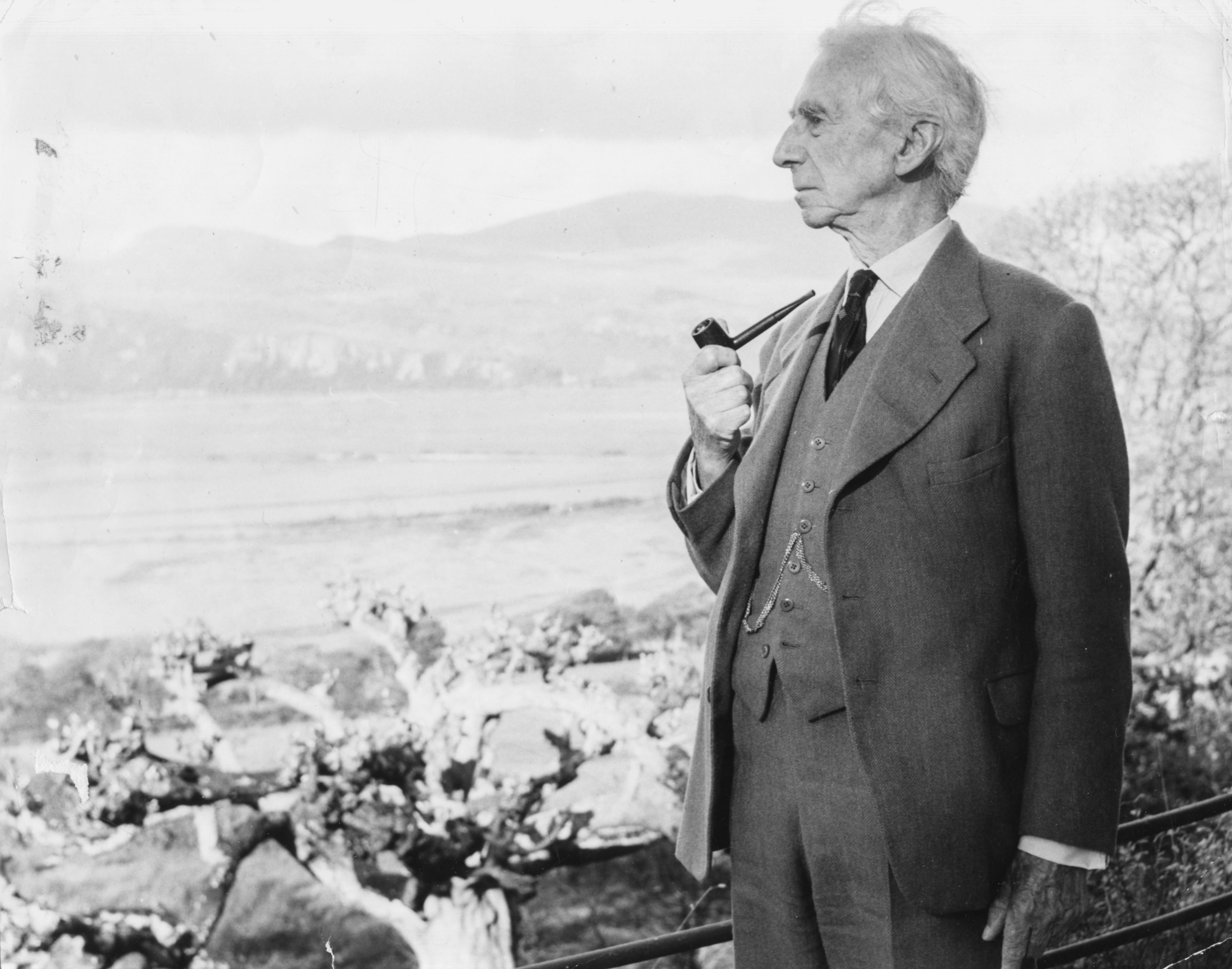 Russell smoking his pipe as he looks out to sea, circa 1960