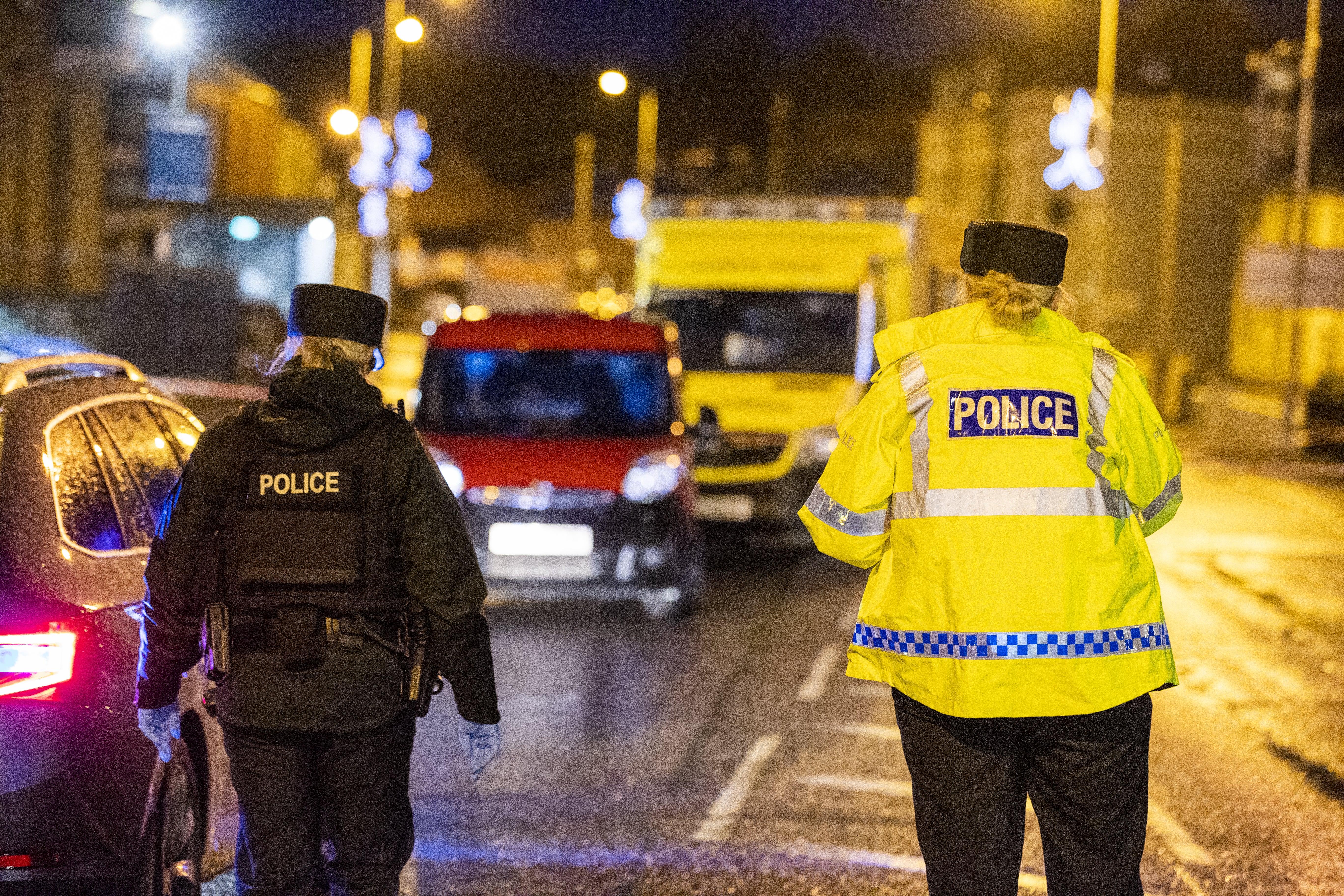 Police officers attend the scene in Downpatrick, Co Down, where a man his 20s was stabbed to death on Monday (Liam McBurney/PA)