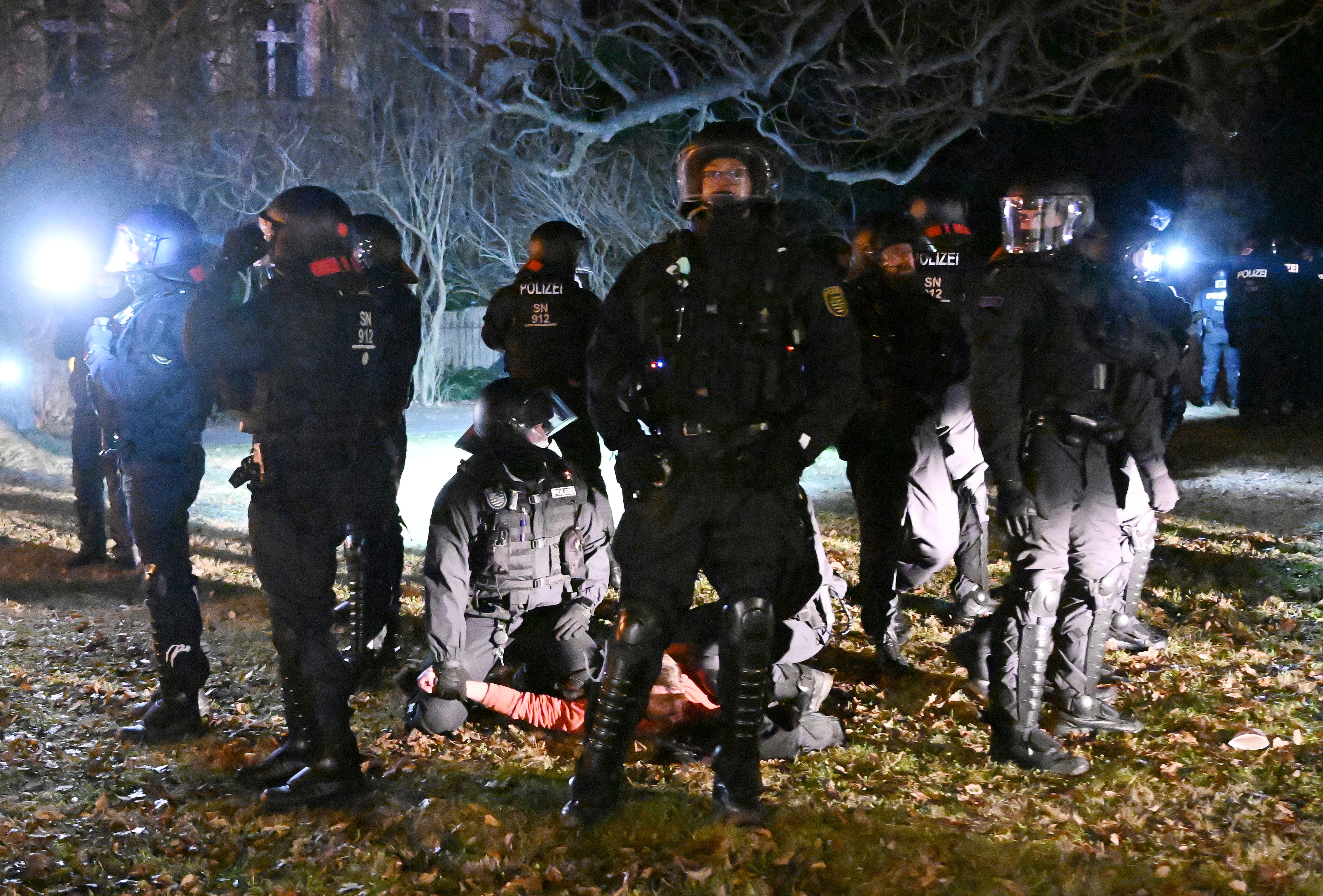 Police officers arrest a demonstrator in the city of Bautzen, Germany, during protests against Corona measures and a possible compulsory vaccination