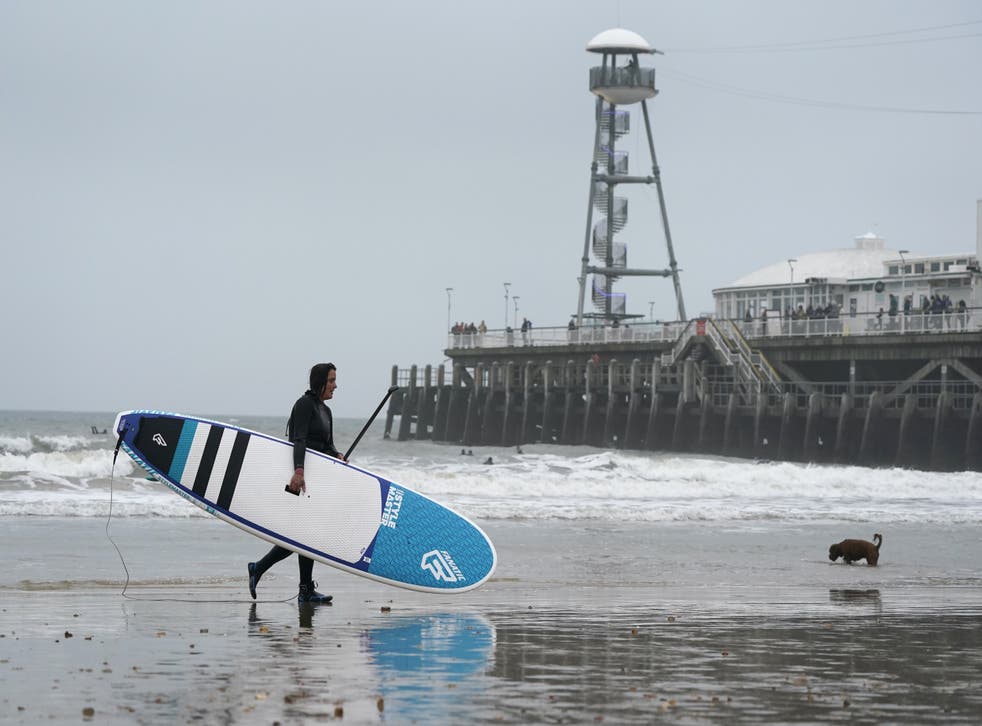 Paddle boarder on Bournemouth beach on New Year’s Eve (Andrew Matthews/PA)