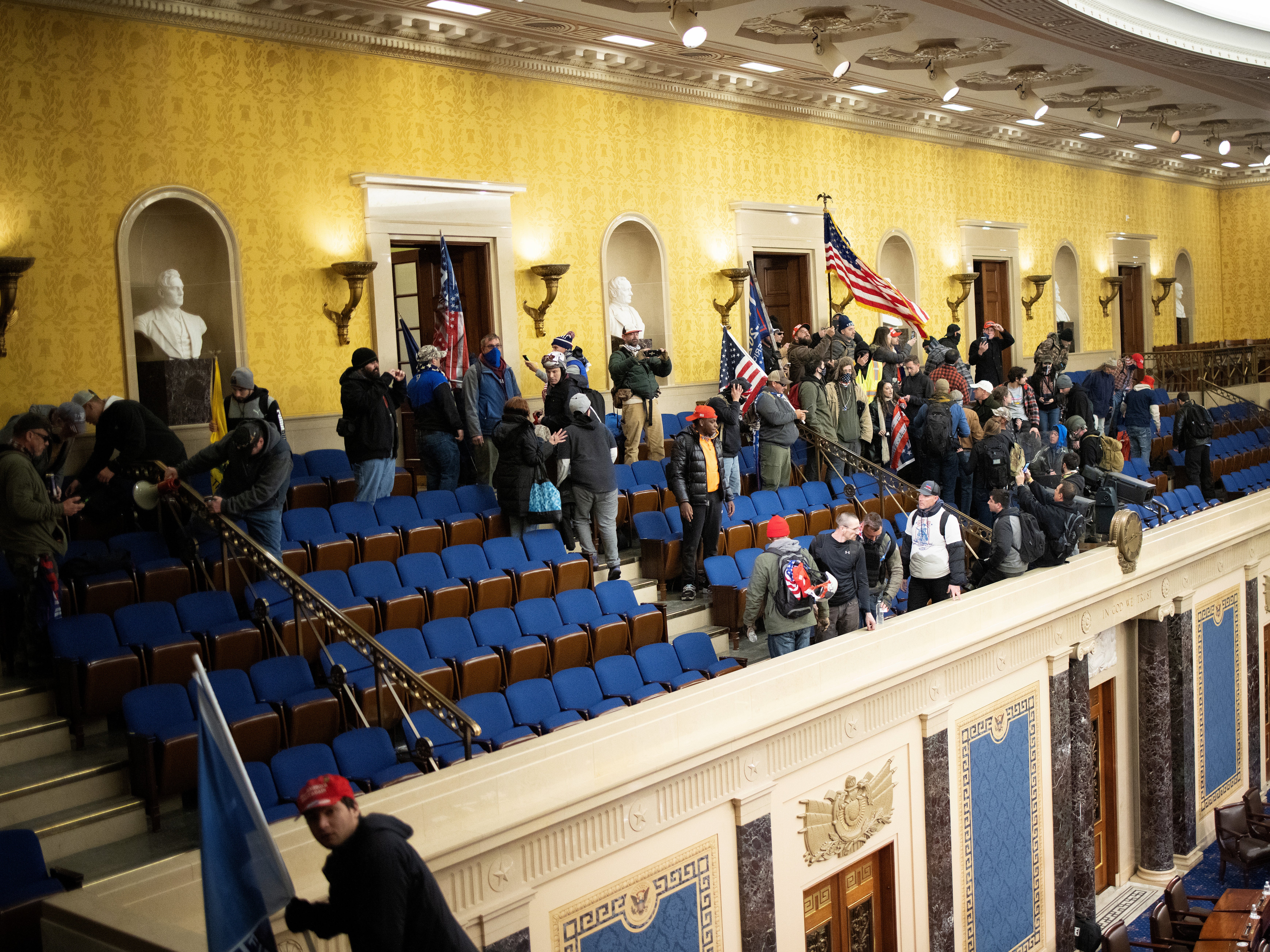 A pro-Trump mob gathers inside the Senate chamber in the US Capitol after groups stormed the building on 6 January 2021